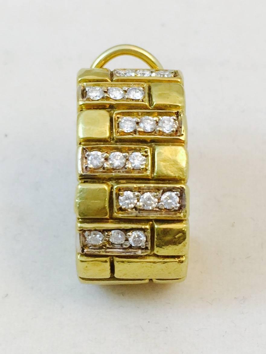 European made and absolutely stunning!  Richness of 18K yellow gold in a hammered finish is accented to perfection with rows of prong set brilliant cut diamonds having an approximate total weight of 1 carat.  G color, VS1 clarity.
Omega back clip