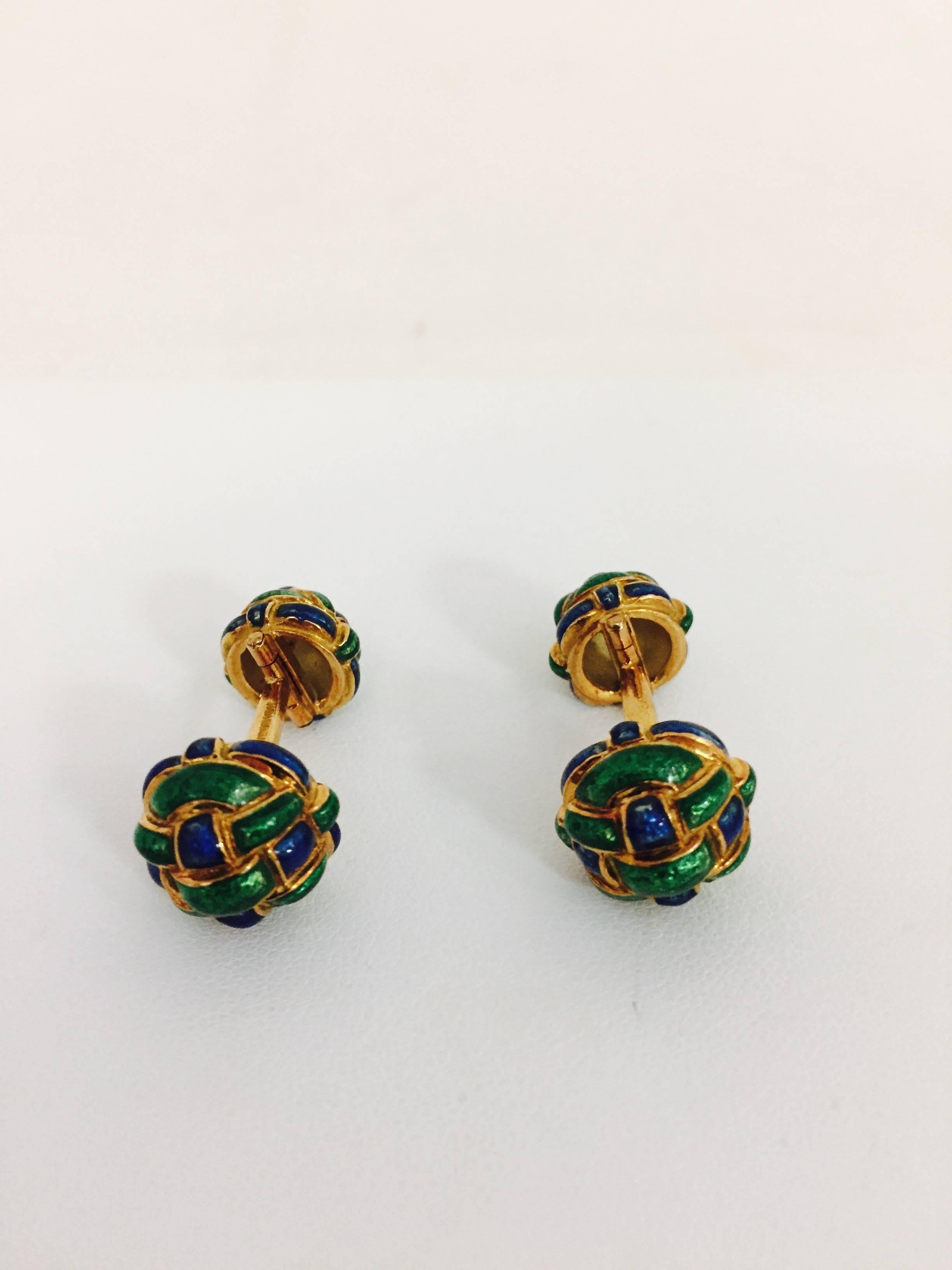 A perfect gift for Dad or Grad!  From the fabled David Webb, these gorgeous 18 karat yellow gold barbell style cufflinks feature intricately woven enamel sections in jewel tone emerald green and sapphire blue.  Oh yes, ladies will be delighted to