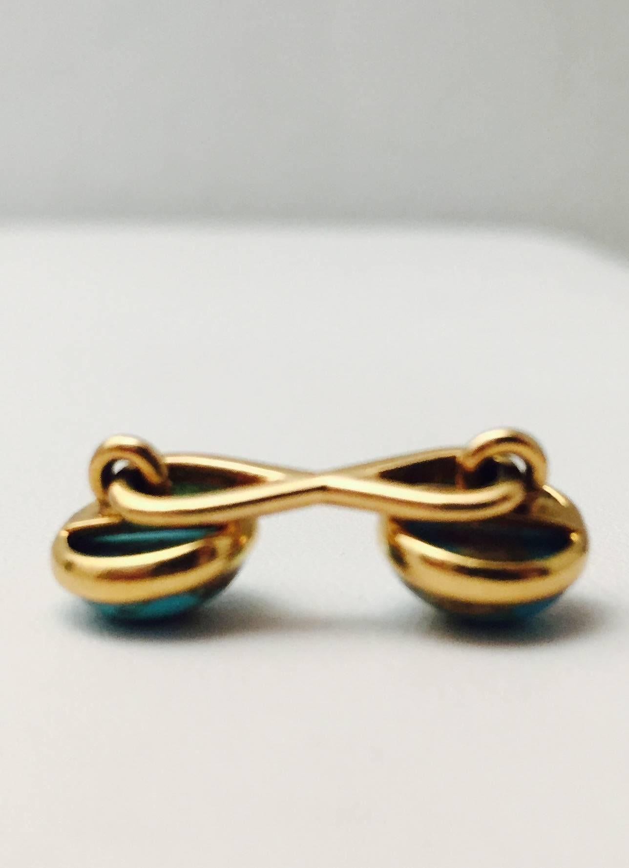 The perfect gift for Dads and Grads! A rare pair of 18 karat yellow gold Infinity link cufflinks, masterfully crafted by Tiffany & Co.  Each end features a bezel set, 10mm turquoise with beautiful matrix.  Highly prized by collectors world wide.