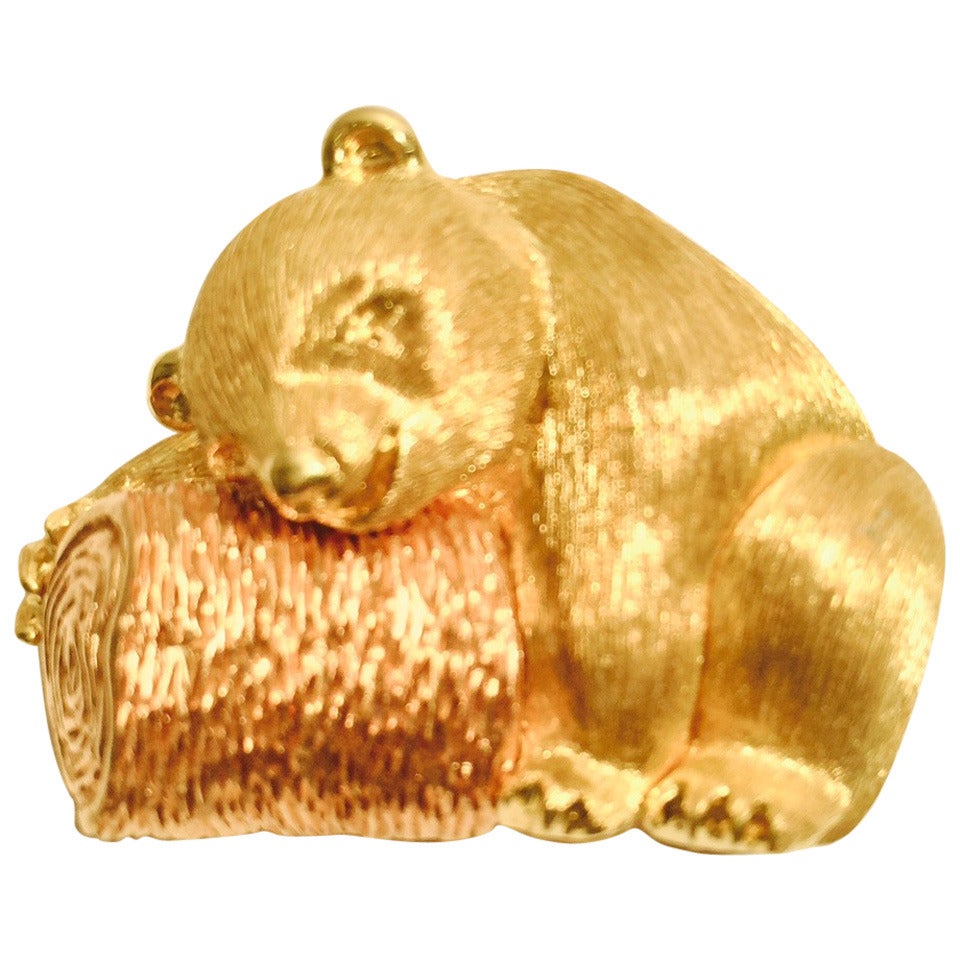 Whimsical and rare Henry Dunay brooch is highly collectible!   Features 18 Karat Yellow Gold bear asleep on a textured 18 Karat Rose Gold log.  Original box included!