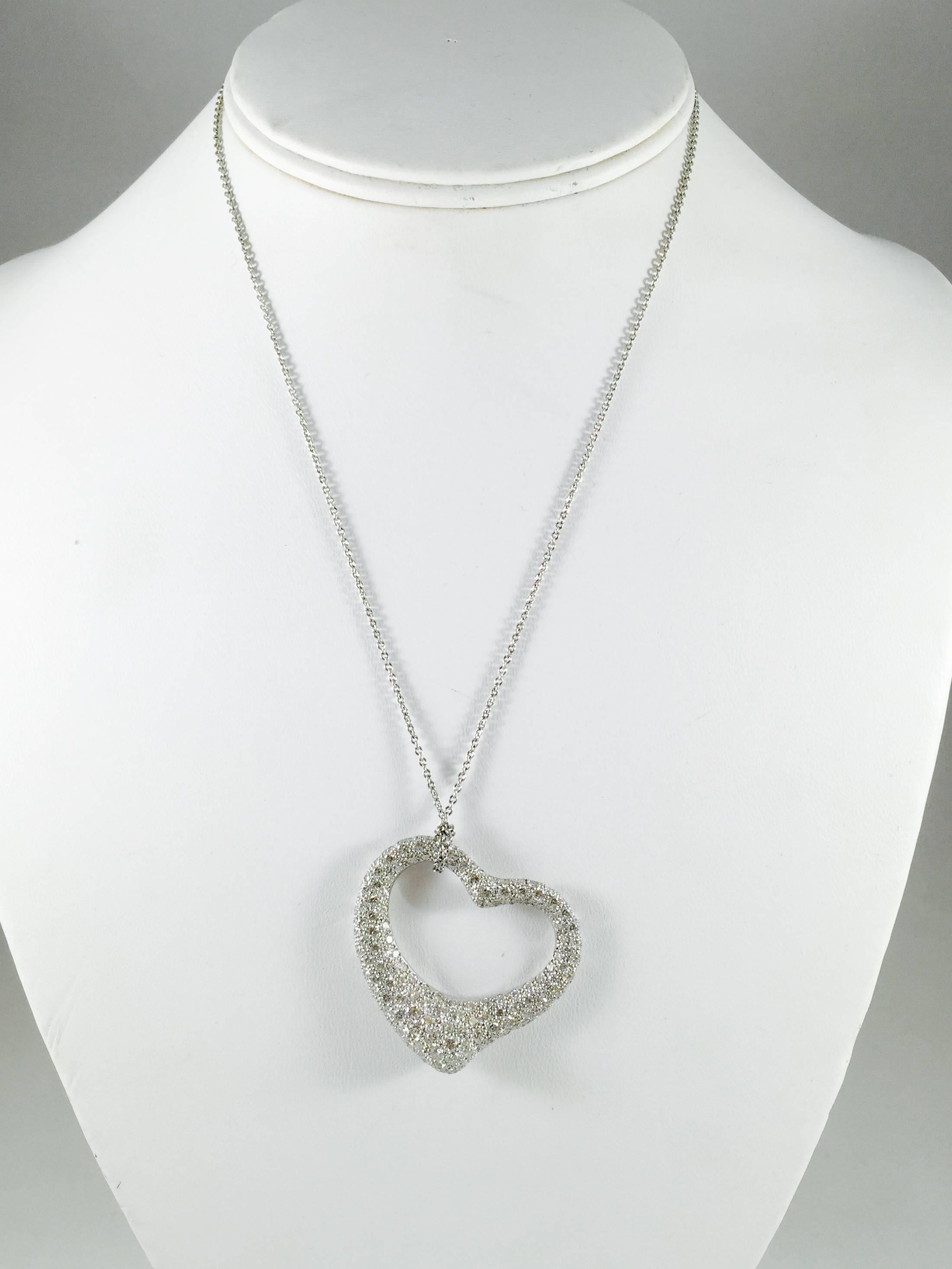 Perhaps the most recognized piece in fine jewelry.  Elsa Peretti's iconic floating heart presented in Platinum by Tiffany & Co.  This heavy, large version is encrusted with 4.00 ct tw of F color, VVS-VS clarity brilliant cut diamonds. Platinum chain