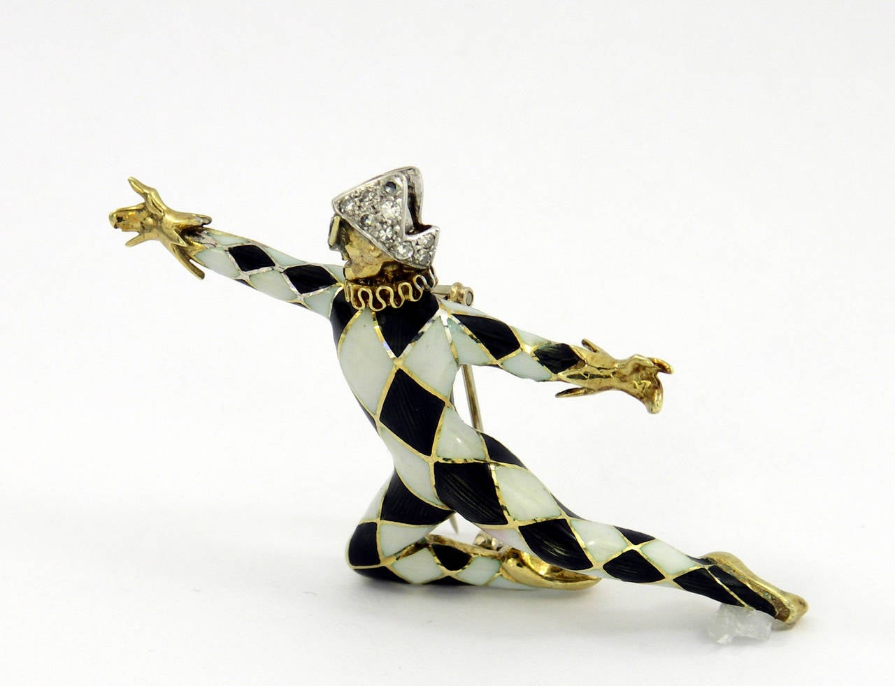 One 14K yellow gold brooch featuring black and white enamel to create this whimsical character. Complete with a masquerade mask, this lively dancer has a white gold double pin, and a white gold hat, that is beautifully pave set with approximately