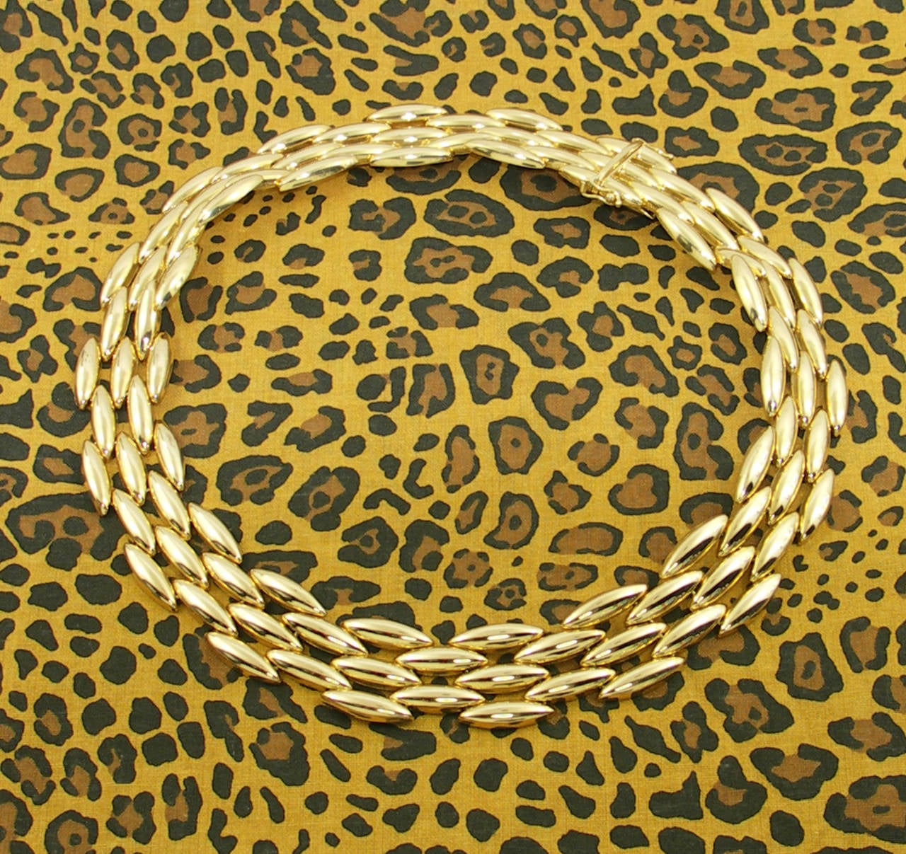 One 18K yellow gold Cartier Necklace, measuring 3/4 of an inch wide, and featuring five rows of the popular 