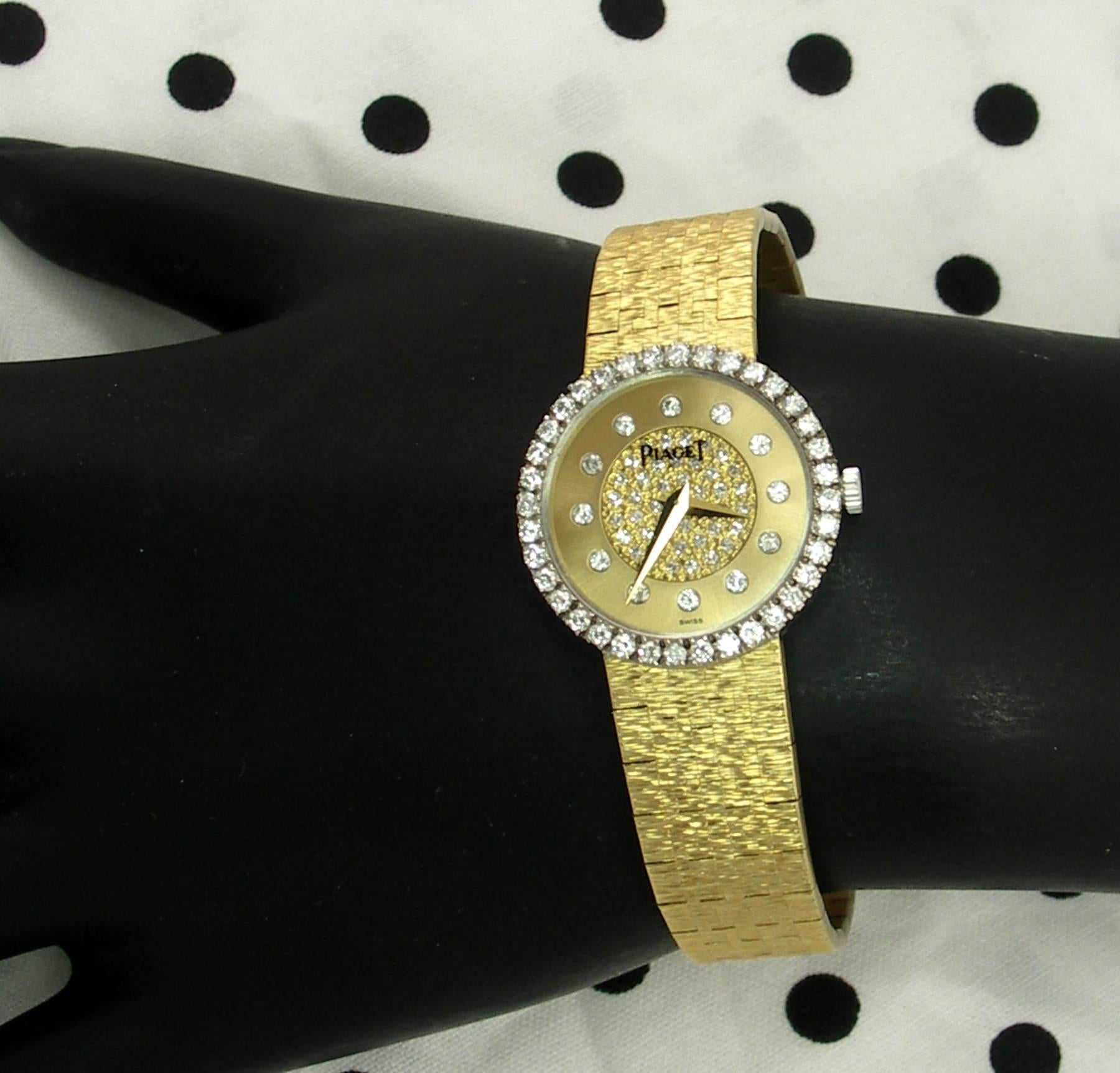 A lady's yellow gold Piaget wristwatch with a unique dial with a pave' set diamond center, and diamond markers. With a case measuring 23mm wide, the bezel is also set with round brilliant cut diamonds for a total approximate weight of 2ct. The watch