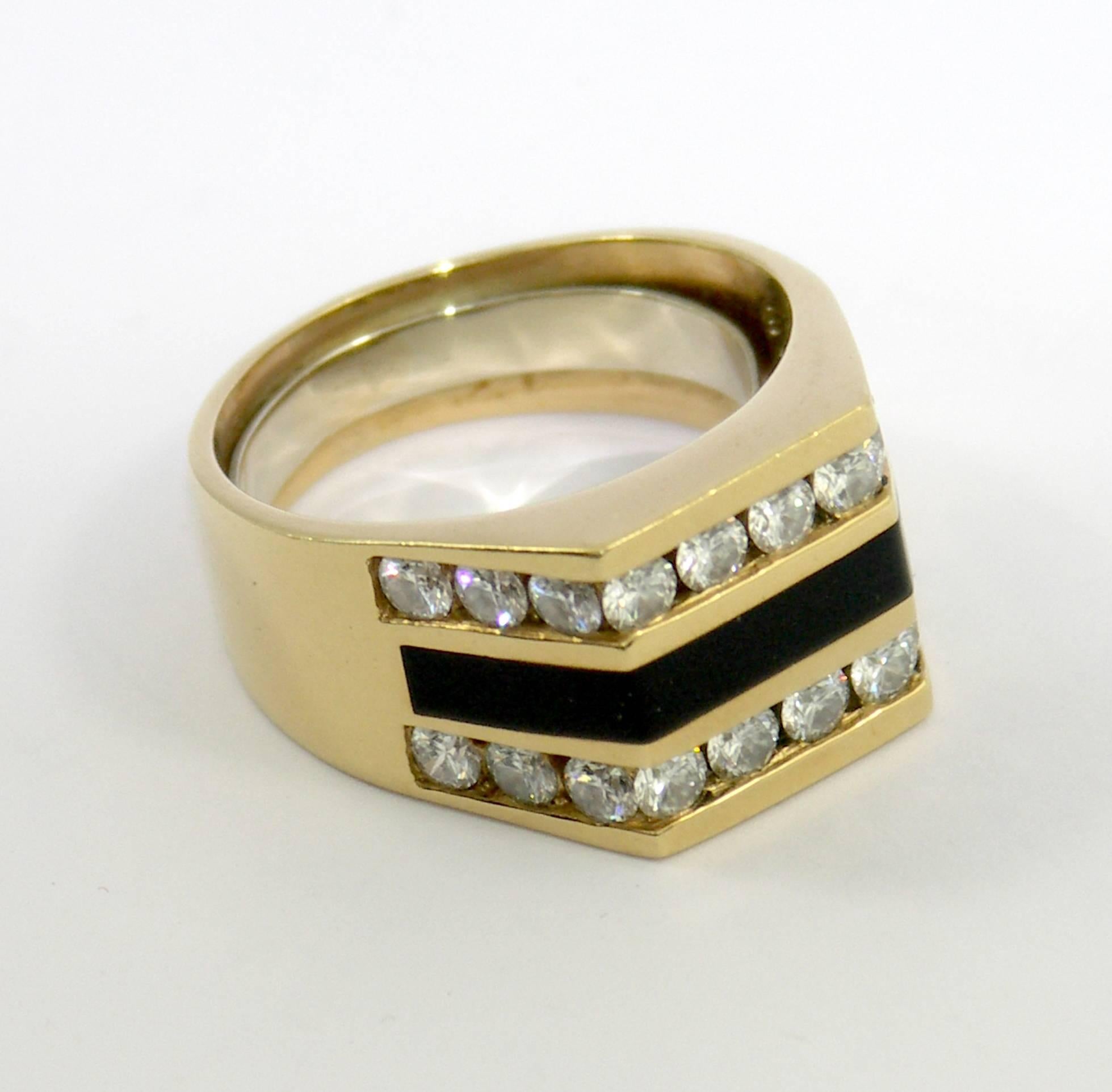 An 18K yellow gold ring with an inlaid black coral center, and two rows of channel set diamonds, weighing 2.25ct total approximate weight. The 22 round brilliant cut diamonds are of F/G color, and VVS2/VS1 clarity. Ring Size 10