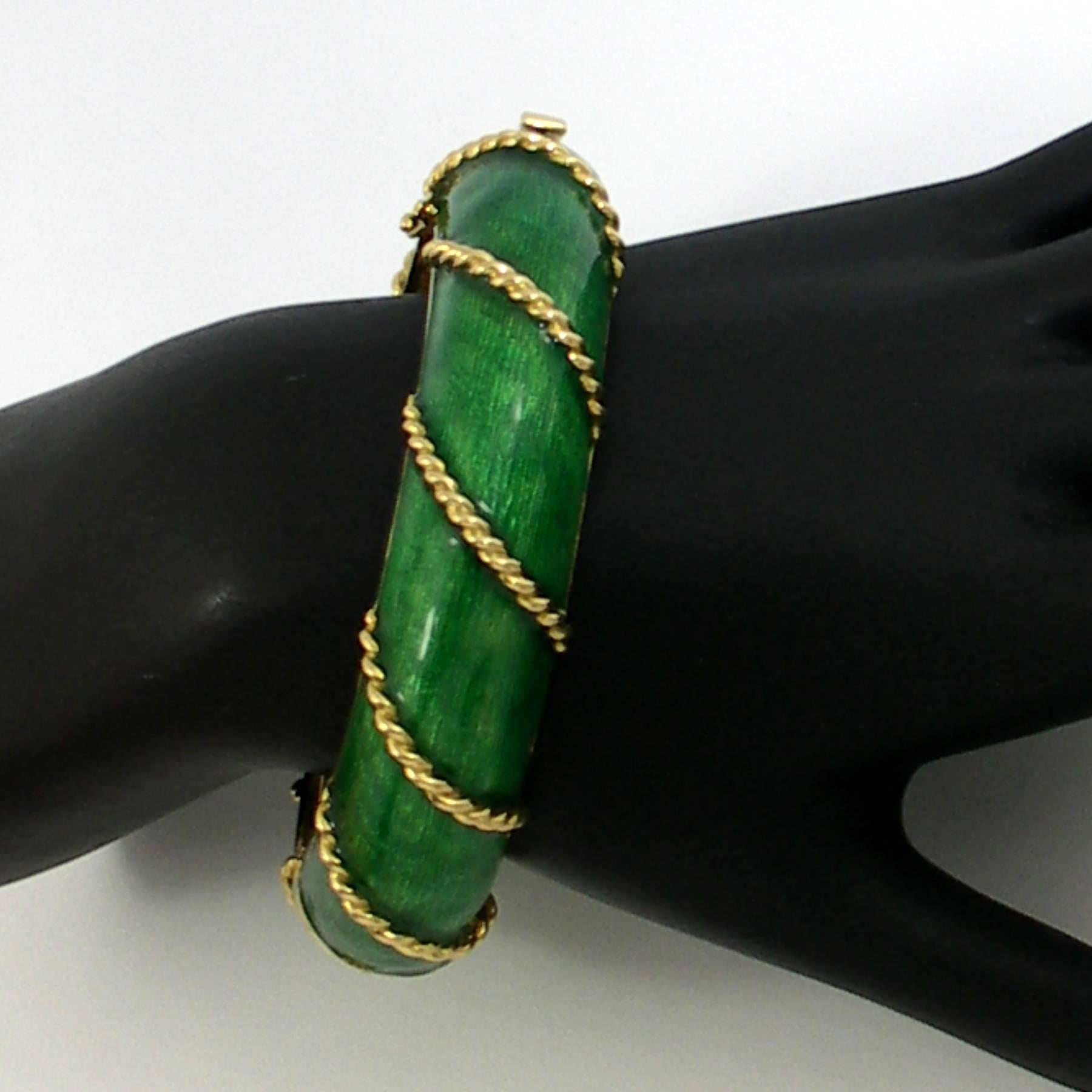 An 18K yellow gold bracelet measuring 3/4 of an inch wide, featuring a vivid green enamel, in cells, divided by a twisted rope design.
Inside Circumference 7 1/4 inches. Weight 83 grams.