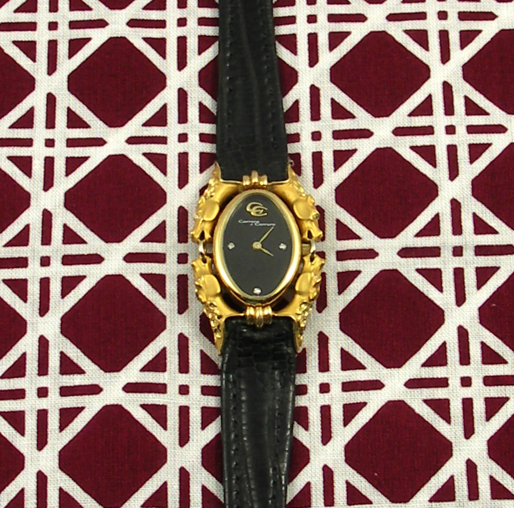 An 18K yellow gold ladies wristwatch by Carrera y Carrera, featuring horse heads on the four corners, set with diamond eyes. Adding to the sleek design is a black dial with diamond markers at the 3, 6, and 9 0'clock positions. This watch will