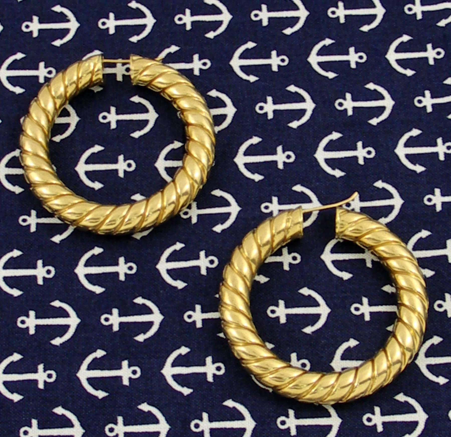 A pair of 18K yellow gold earrings measuring 1 7/8 inches in diameter, and featuring a twisted rope design. The extra large earrings have a strong yet casual presence, and are hallmarked from the Arezzo Region of Italy.