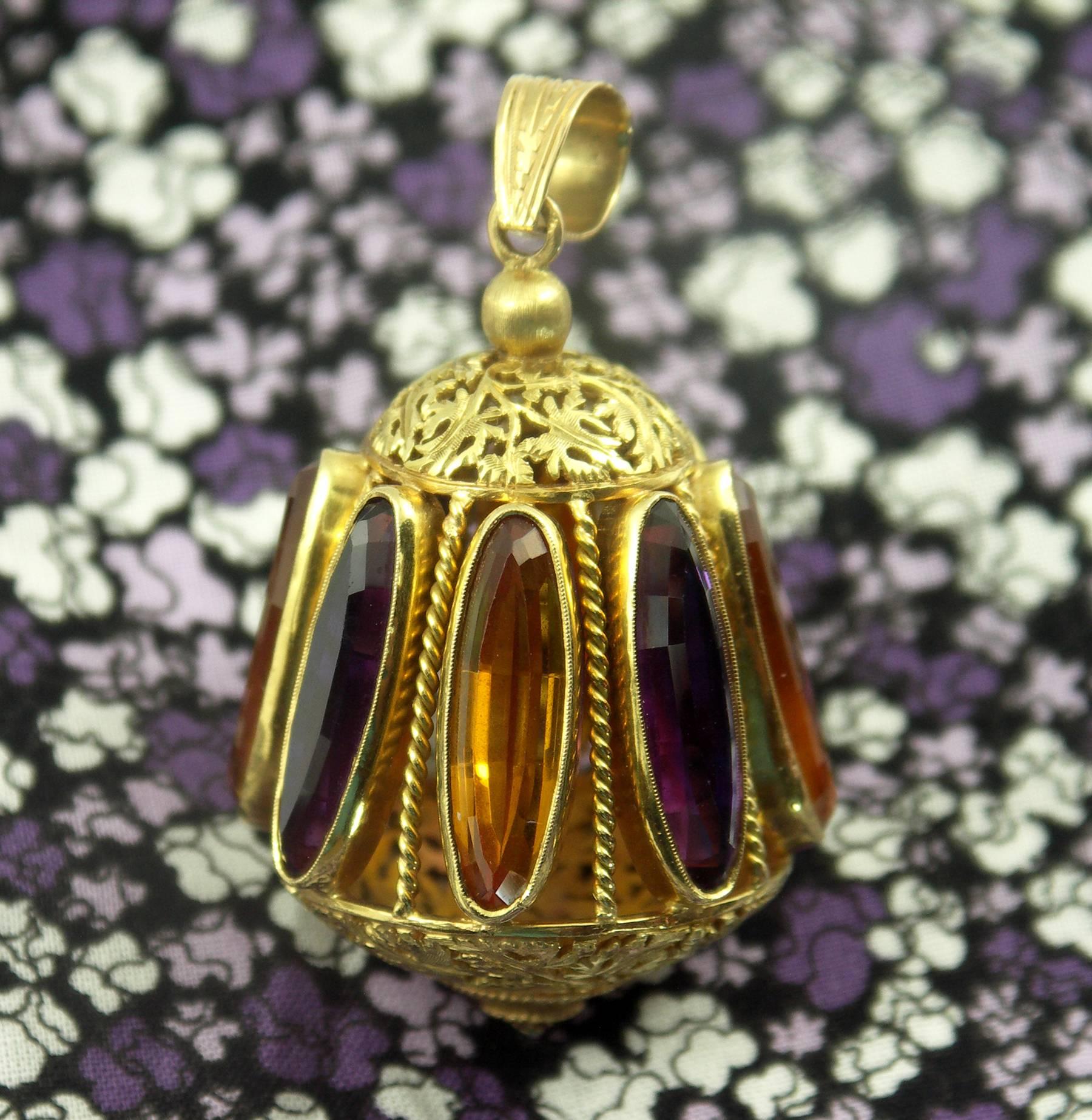 An amazingly large 18K yellow gold charm measuring 2 1/2 inches long and 1 1/2 inches wide, set with alternating faceted amethyst and citrine. With beautiful twisted wire supports between each stone, this pendant is further embellished with organic