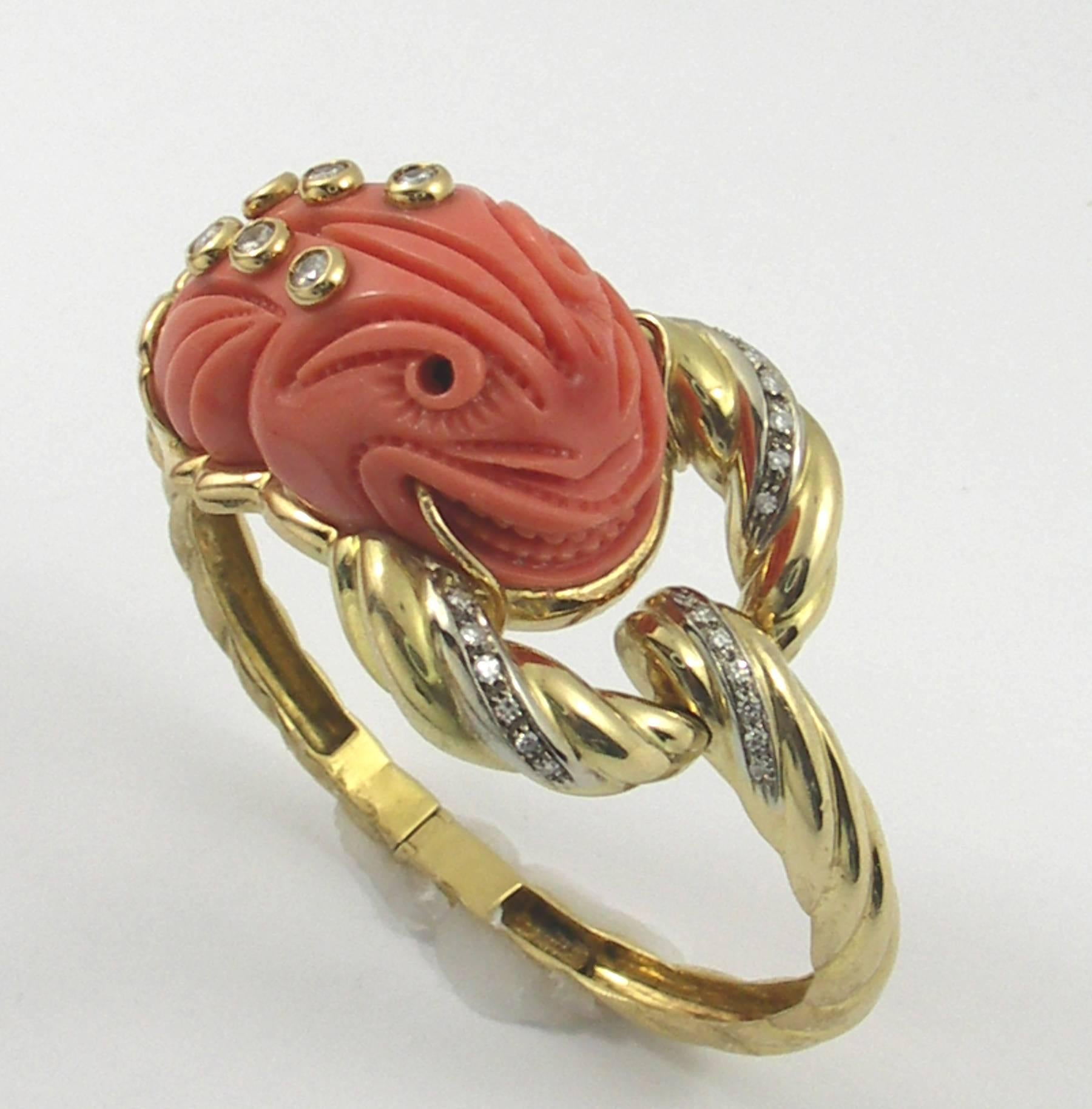 One ladies 18K yellow gold bracelet signed Mario Fontana, featuring an intricately carved coral creature. Measuring 1/4 of an inch wide at the clasp, it opens up to a substantial 2 5/8 inches at the widest part of the design area. This beautiful