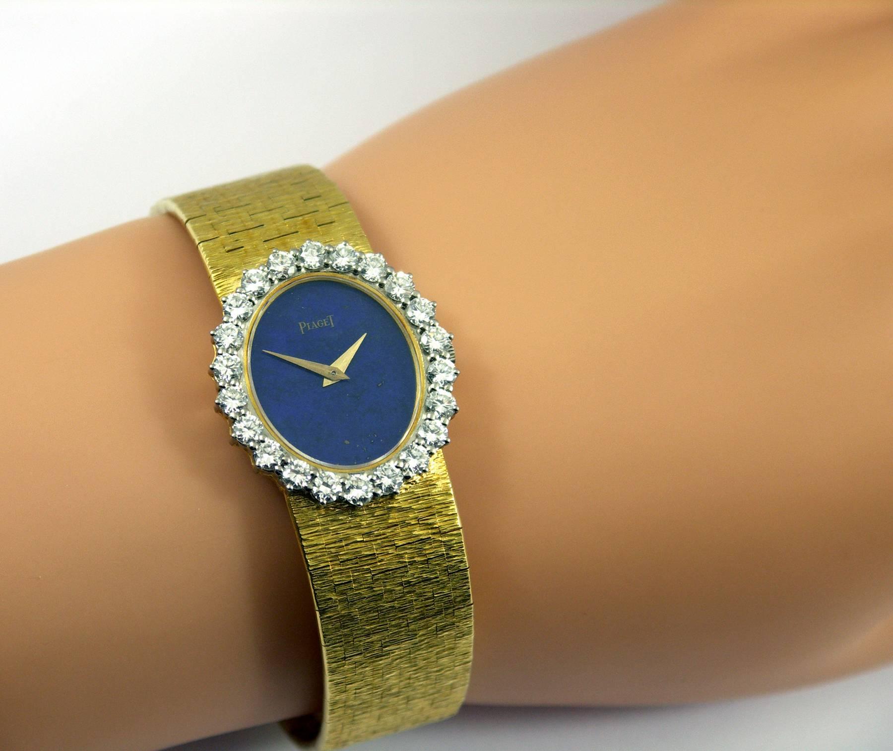 A lady's 18K yellow gold Piaget wristwatch with a bezel measuring 1 1/8 inches long, and 1 inch wide. The Dial is a deep blue lapis lazuli with few inclusions. The bezel is set with 22 round brilliant cut diamonds weighing 2.25ct total approximate