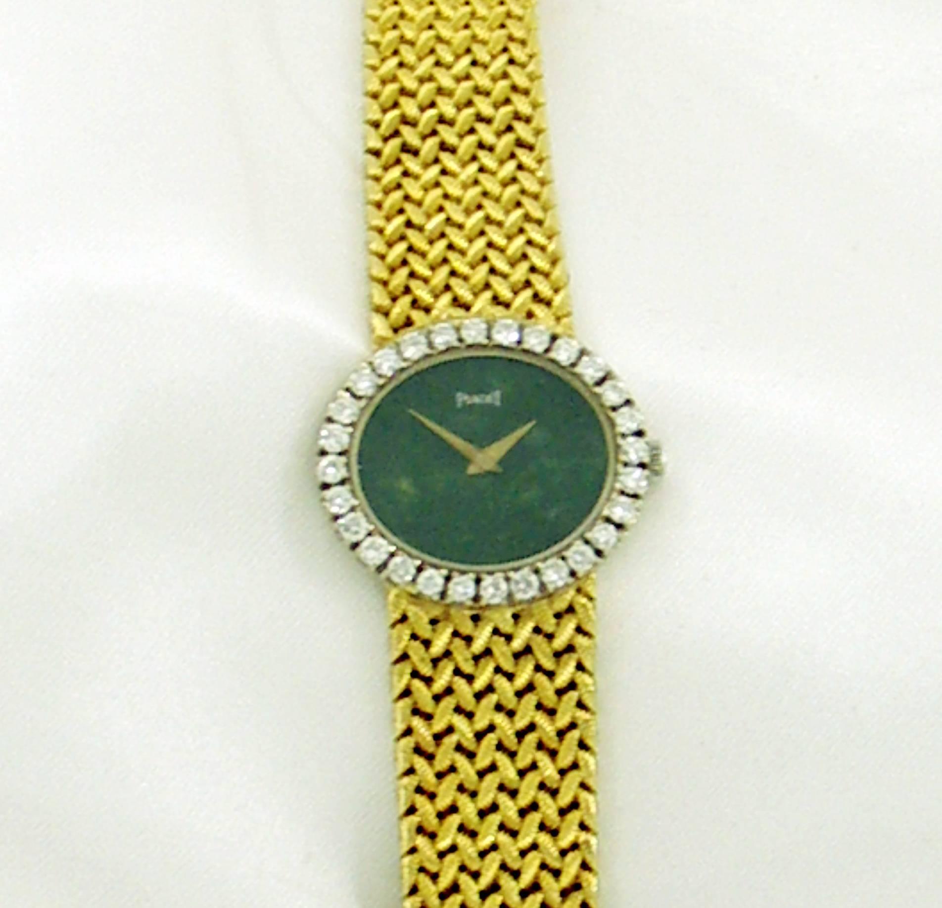 An 18K yellow gold lady's wristwatch by Piaget. This watch features a green jade dial measuring 18mm X 20mm, and surrounded by a round brilliant cut diamond bezel measuring 24mm X 27mm, and set with 28 diamonds weighing 1.75ct total approximate