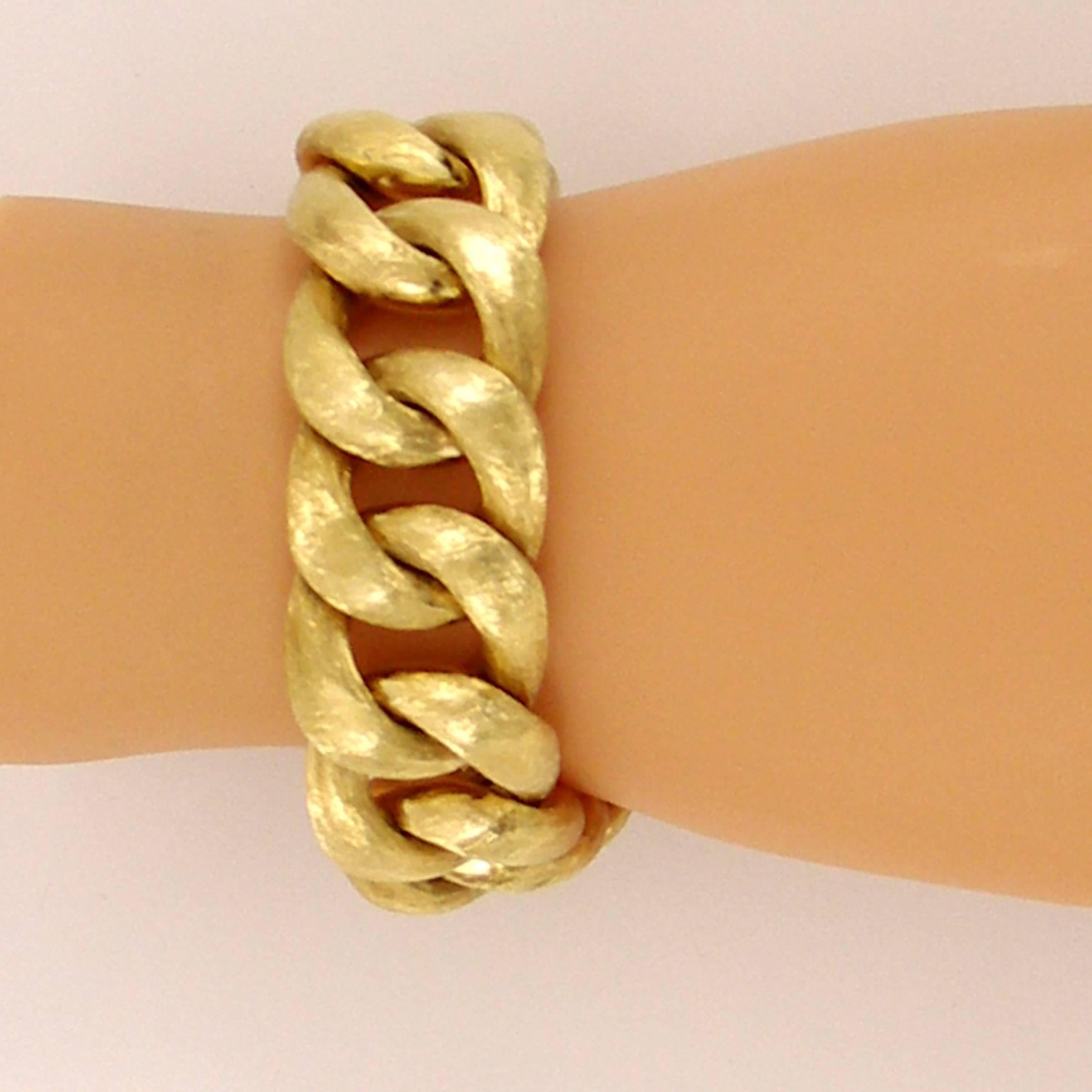 A 14K yellow Gold Bracelet measuring 7 1/2 inches long, and 7/8 of an inch wide, with a deep Florentine Finish. Bracelet is high polished on reverse. 
