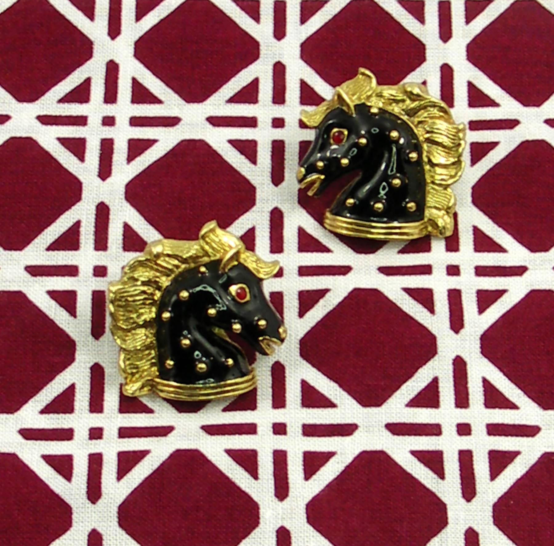 A pair of ladies 18K yellow gold equestrian themed earrings by Hidalgo. Measuring just over an inch square, they are beautifully enameled in black with red eyes, and flowing manes. Weight 20 grams.