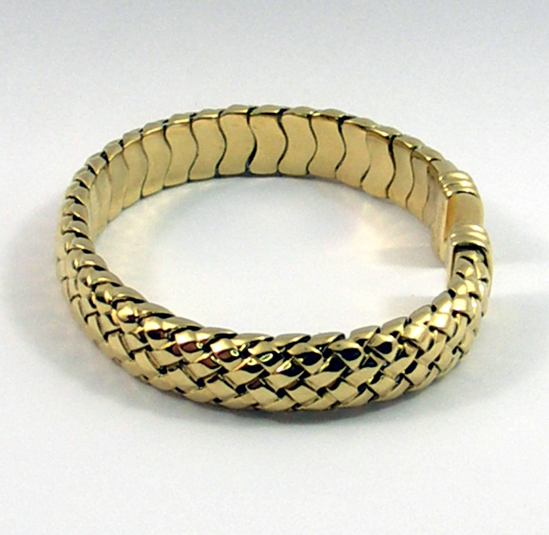 18K yellow gold woven design bracelet measuring 9.5mm wide, inside circumference 6 inches. Signed Tiffany & Co.