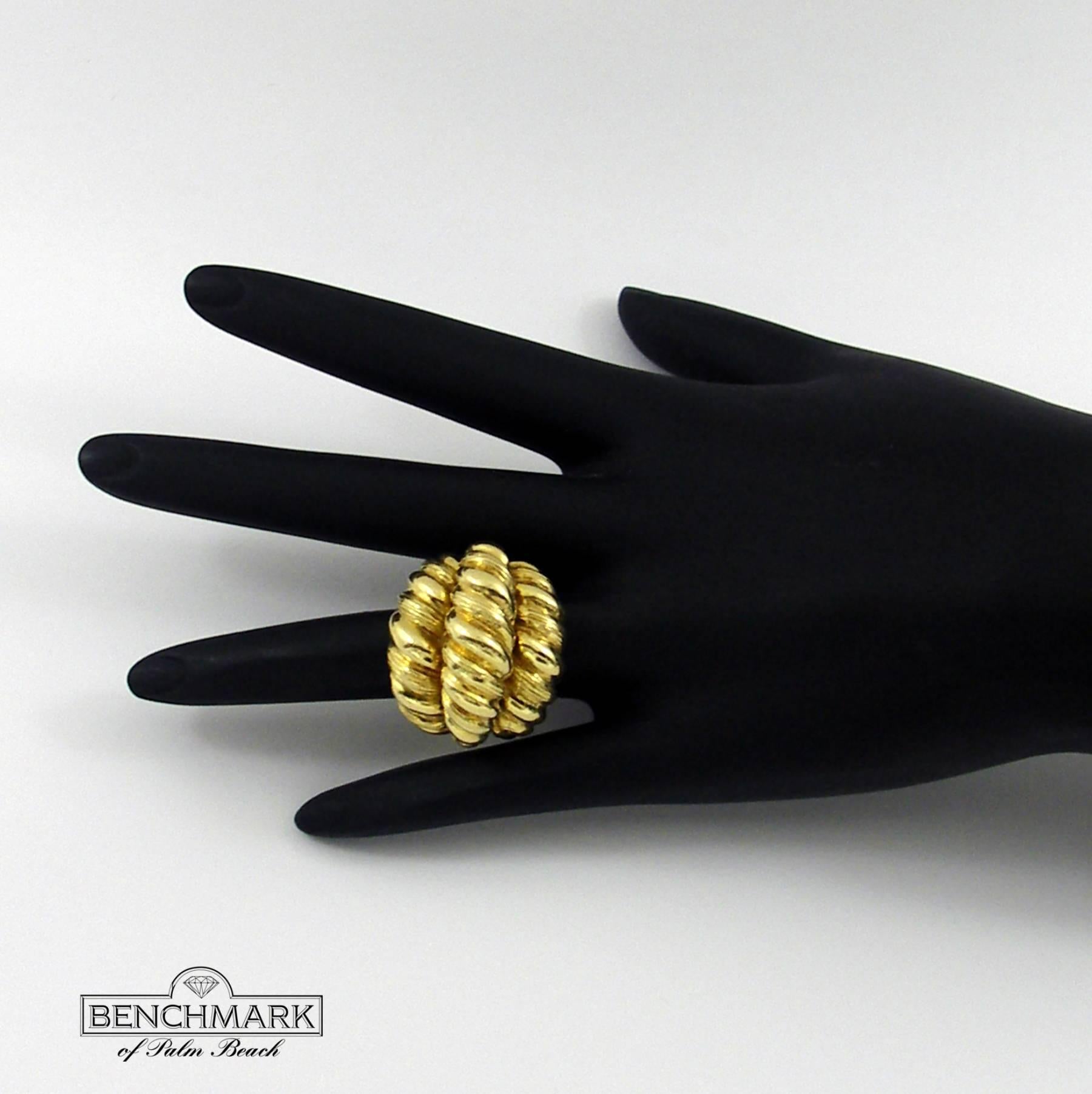 An 18K yellow gold ring featuring a coiled appearance, and comprised of three sections measuring a combined 1 3/8 inches wide. 
Signed Hammerman Brothers
Size 6