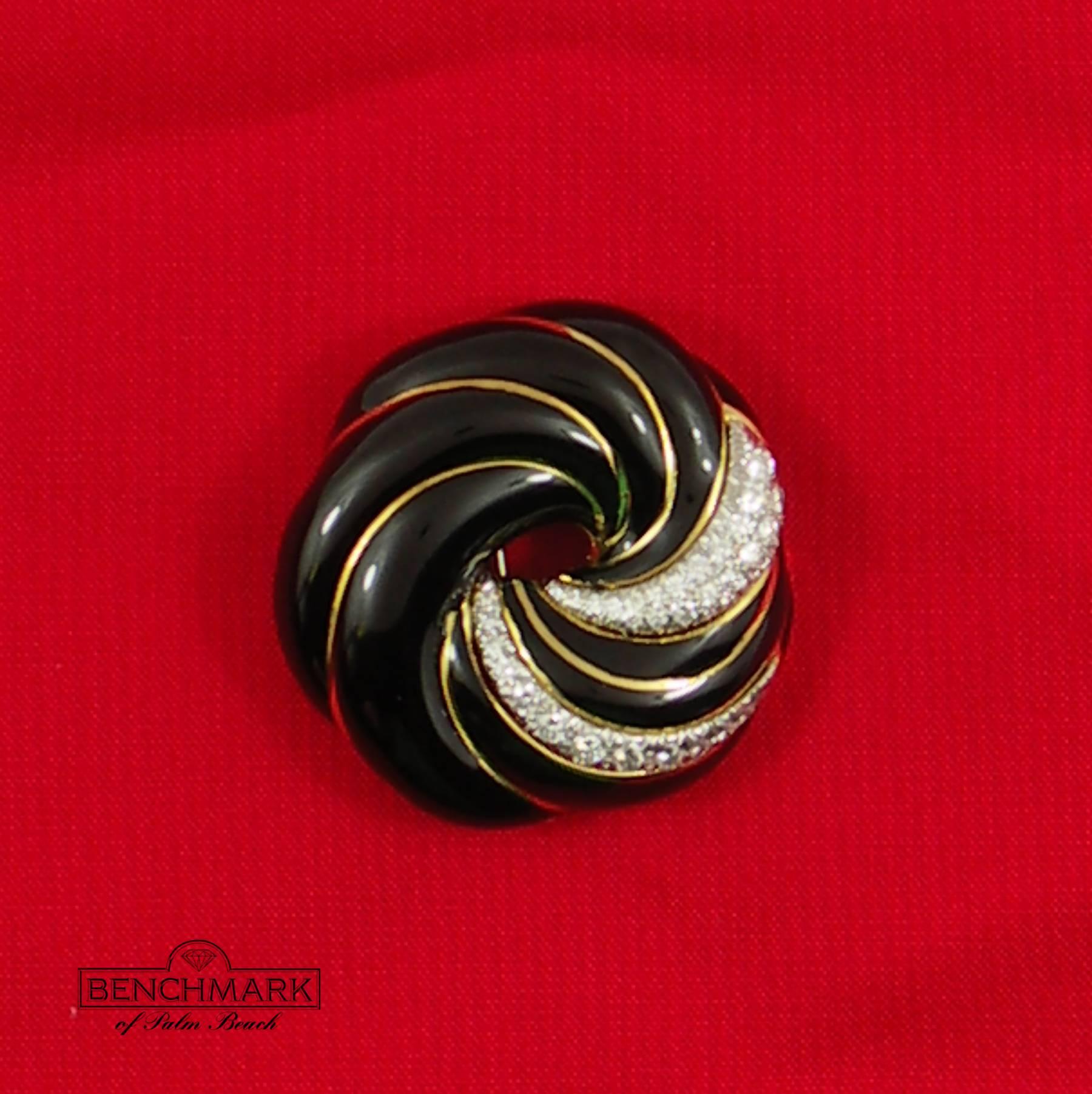 One ladies 18K yellow gold brooch measuring 1 3/4 inches in diameter, of a spiral design with black enamel, and set with 27 round brilliant cut diamonds weighing 1.85ct total approximate weight of overall F/G color and VVS2/VS1 clarity, set in