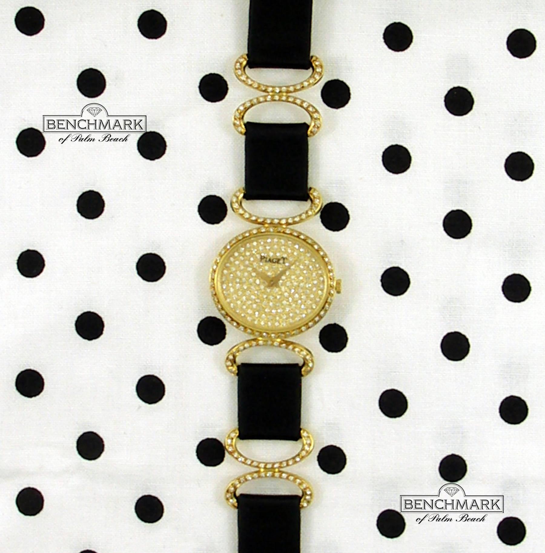 An 18K gold and diamond wristwatch, masterfully designed, with 2 sections of strap on each side, connected by gold and diamond stations. The case measures 24mm X 27mm, with diamond encrusted lugs to match the connectors on the strap, and the buckle.