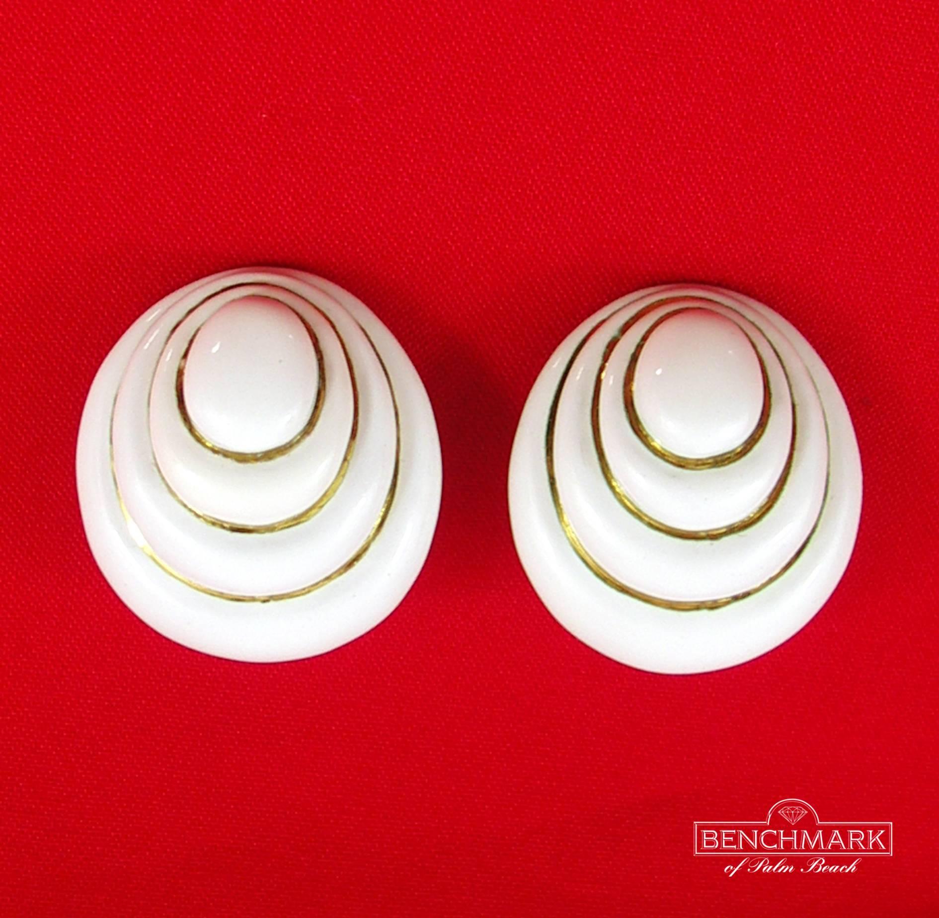 With a shell inspired design, these earrings feature four tiers of white enamel, with bright 18K yellow gold. Measuring 1 3/8 inches long and 1 3/16 inches wide, they are a grand scale but weigh a manageable 43.8 grams. Signed Webb for David Webb.