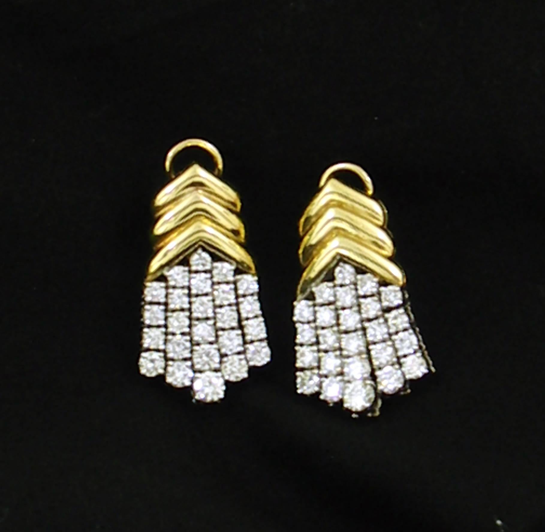 A pair of ladies 18K yellow and white gold earrings comprised of a yellow gold top comprised of three chevrons, and a bottom with five tassels of diamonds set in white gold. Each earring is set with 24 round brilliant cut diamonds for a total of 48