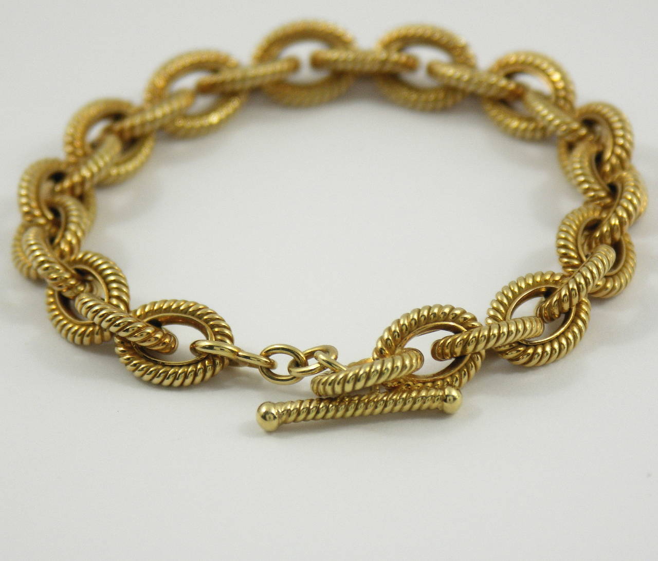 One 18K yellow gold bracelet by Tiffany & Co. measuring 8 inches long, and comprised of 26 links. Each link, measures 3/8 of an inch wide and features a twisted rope design. Each link is constructed in such a way that the twisted rope actually sits