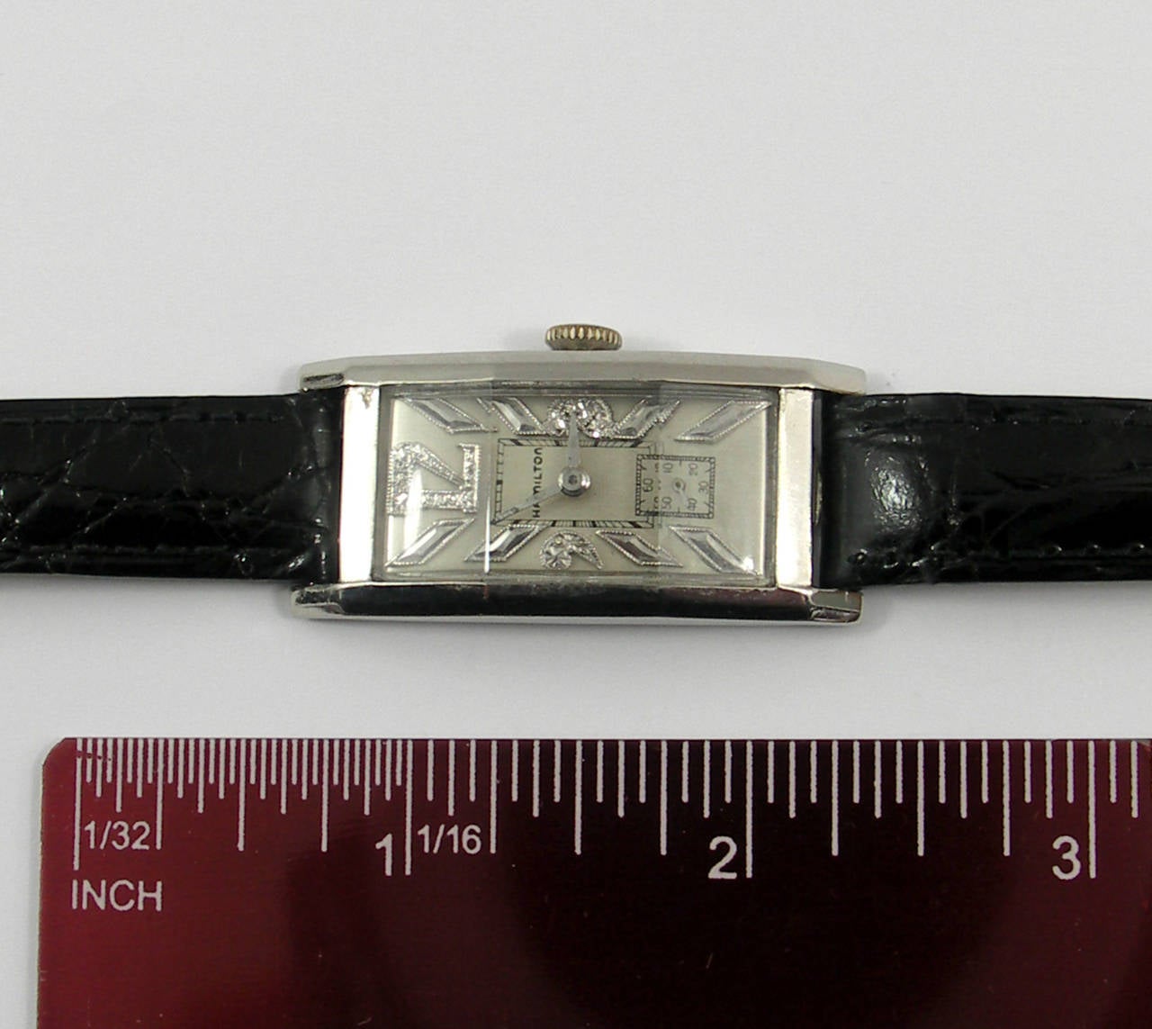 A handsome mid-century Hamilton, Curvex, wristwatch in palladium, with diamond dial, and original faceted watch crystal.