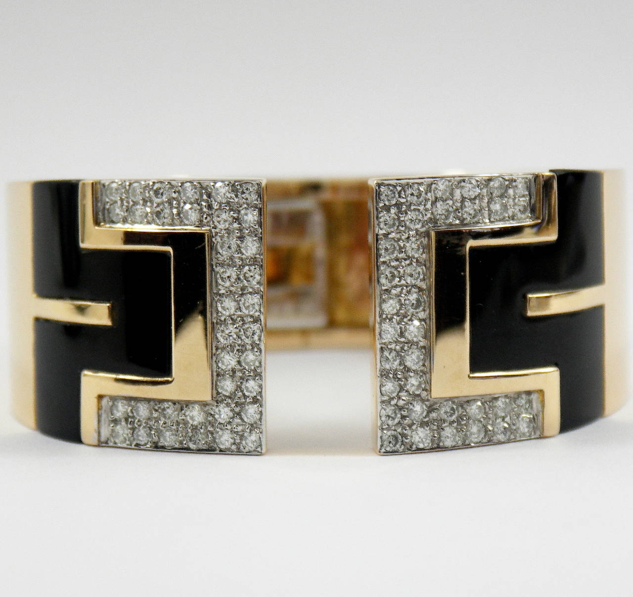 An 18K faint, pink gold, split-front bracelet featuring a combination of geometric, and 