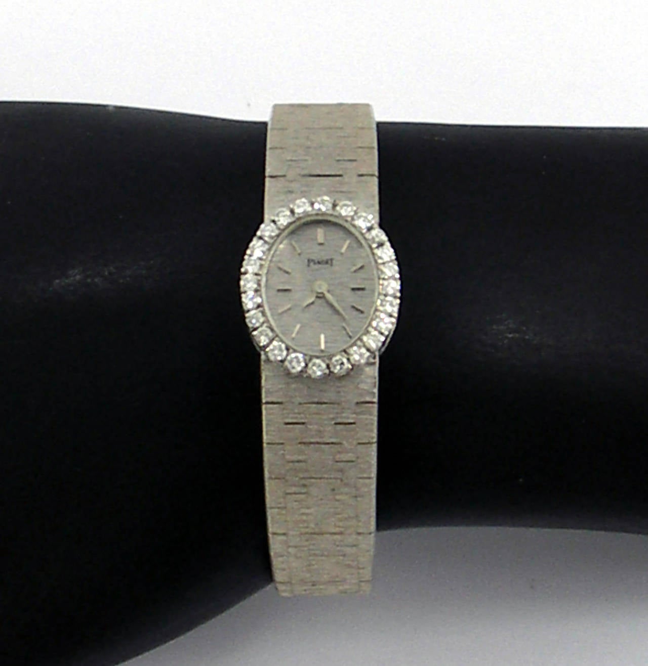 One ladies 18K white gold Piaget wristwatch with a bezel measuring 19mm long, and 16mm wide. The bezel is set with 24 round brilliant cut diamonds, weighing 0.75ct, total approximate weight. The mechanical movement is in excellent condition, and is