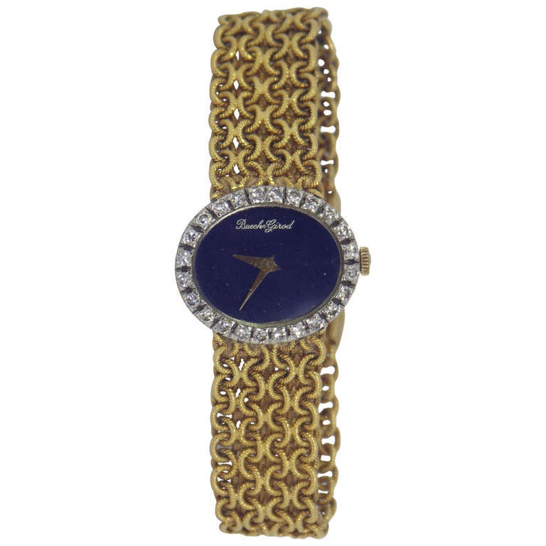 Beuche-Girod lady's 18k yellow gold and diamond bracelet watch, circa 1965, with a head measuring an inch wide and 7/8ths of an inch long, and surrounded by approximately 2 cts of round brilliant-cut diamonds. The dial is lapis lazuli. The bracelet
