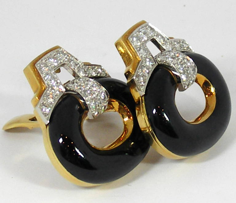 One Pair of 18K yellow gold and platinum earrings. At the top of each earring, are 33 round brilliant cut diamonds set in platinum. The lower section features an enameled oval disc 1 1/4 inches wide, and 1 inch long. Overall the earrings measure 1