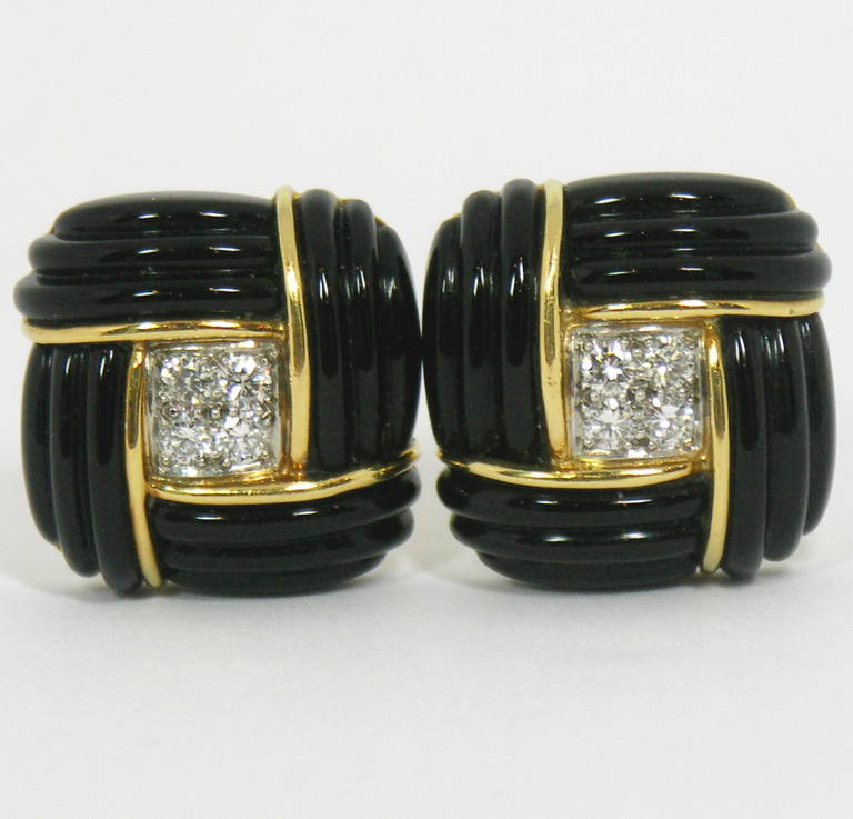 One pair of ladies 18K yellow gold earrings by Charles Turi, each beautifully accented by four sections of fluted onyx, giving a squared knot appearance. This is centered around the four round brilliant cut diamonds in each earring for a total