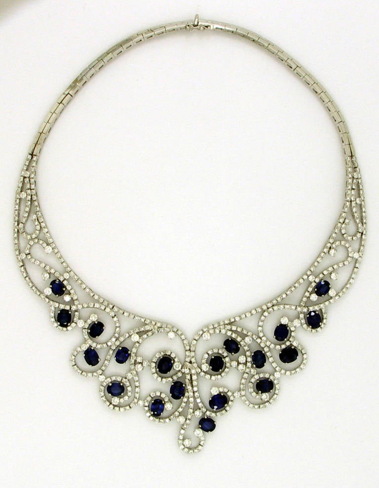 One 18K white gold necklace set with 19 oval faceted blue sapphires, weighing 35ct total approximate weight. This fabulous necklace is comprised of 7 1/2 inches of high polished, white gold links, and the front portion, measuring 8 1/2 inches by 2