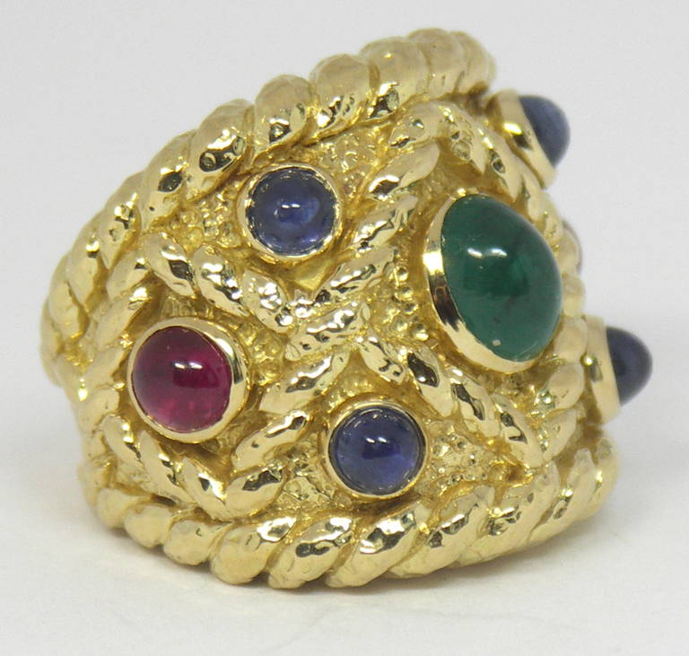 One dramatic cigar band ring set with assorted gemstones by David Webb. This stylish ring is one inch wide on the finger, and tapers down to 1/4 inch wide at it's base. The design area features rope motifs, as well as rope edging. It is set with