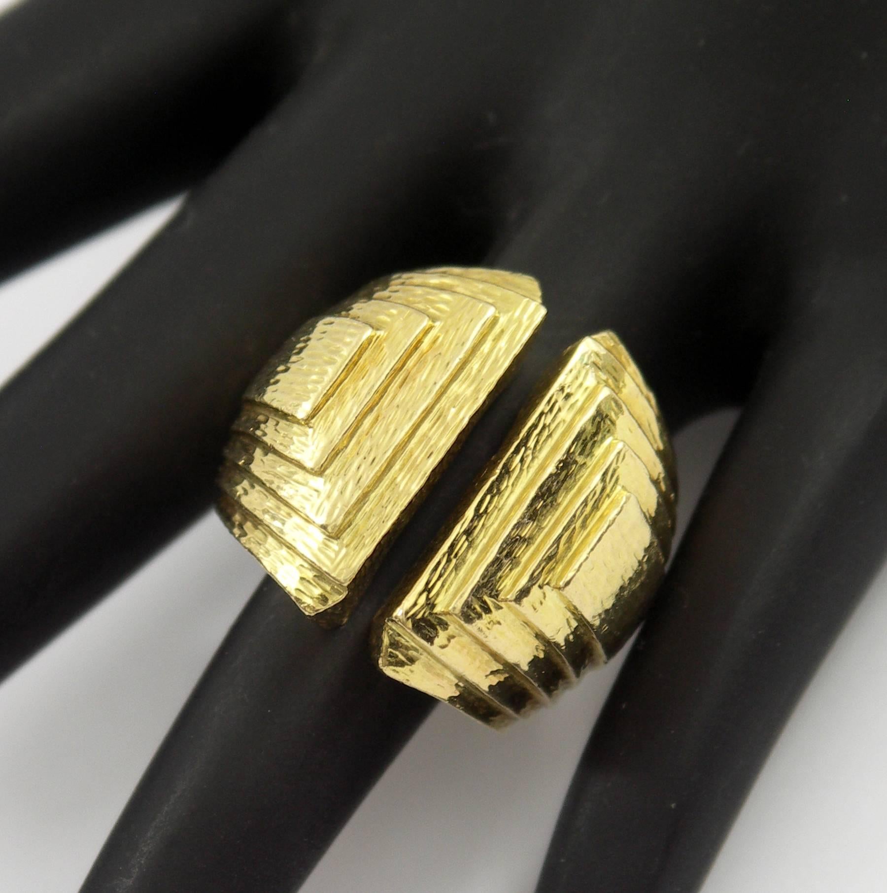 A split front band in 18K yellow gold, by David Webb, featuring five levels of hammered gold. This ring is a size 6 and tapers in width from 7/8 of an inch down to 1/4 inch.
