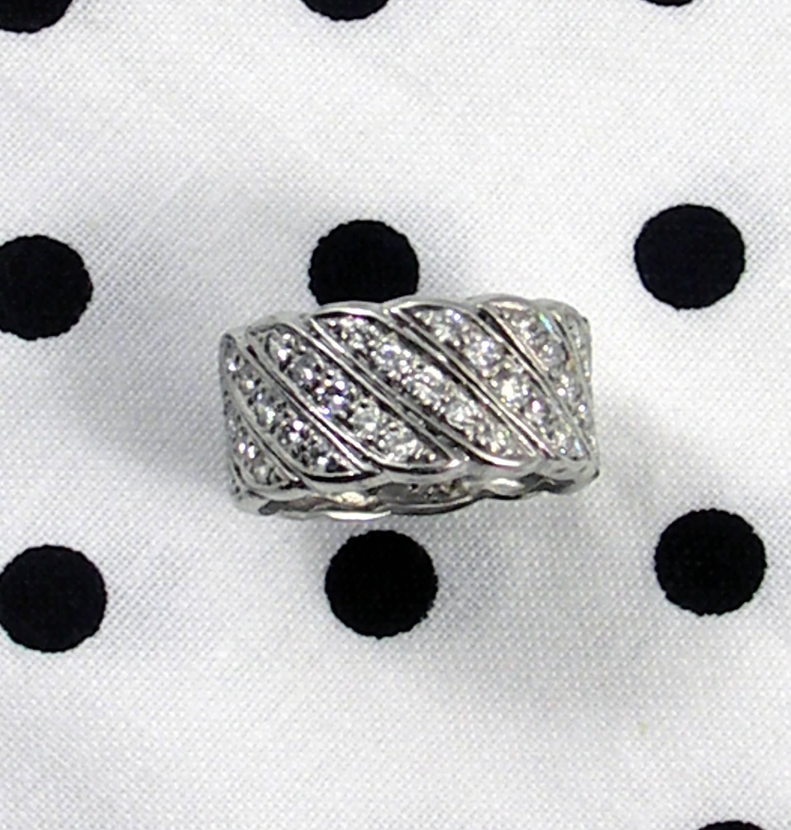 A platinum band set with 70 round brilliant cut diamonds weighing 2ct total approximate weight.
Size 7
