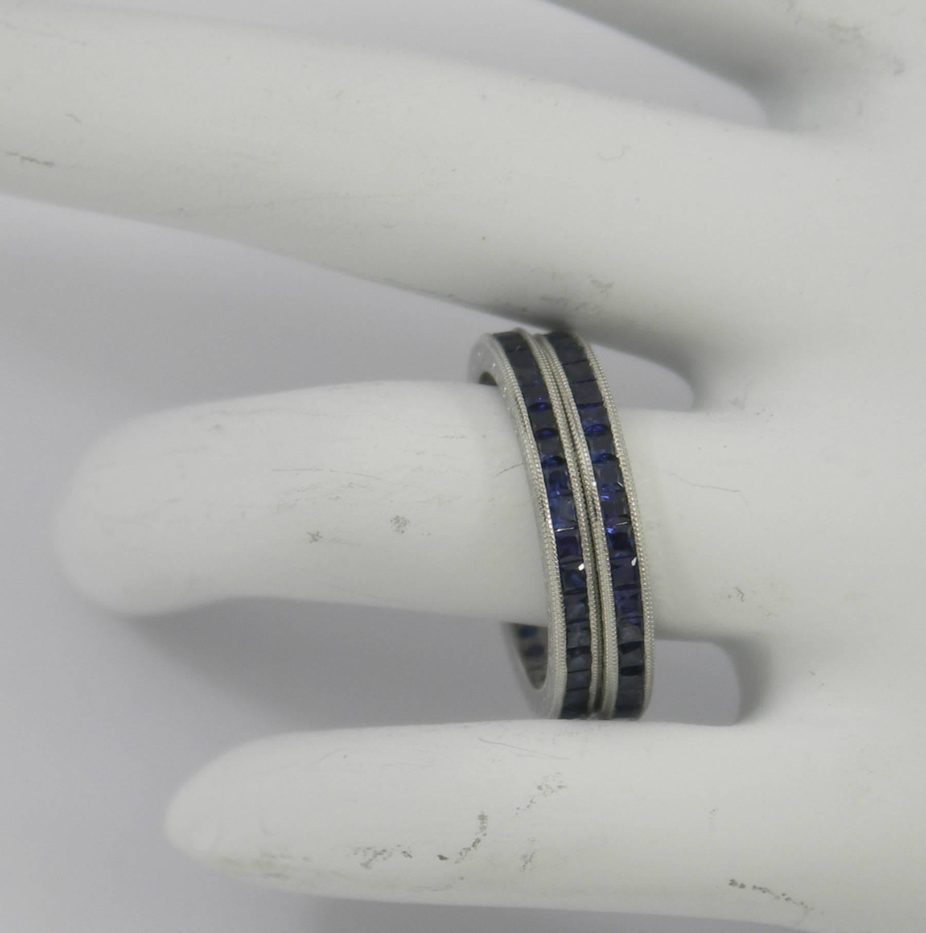 A pair of platinum eternity bands, with channel set, French cut sapphires, weighing 2 2/3 ct total approximate weight. Edges are millegrained, and the sides are beautifully engraved.
Size 6 1/2
For accompanying band seen in picture 5, please view