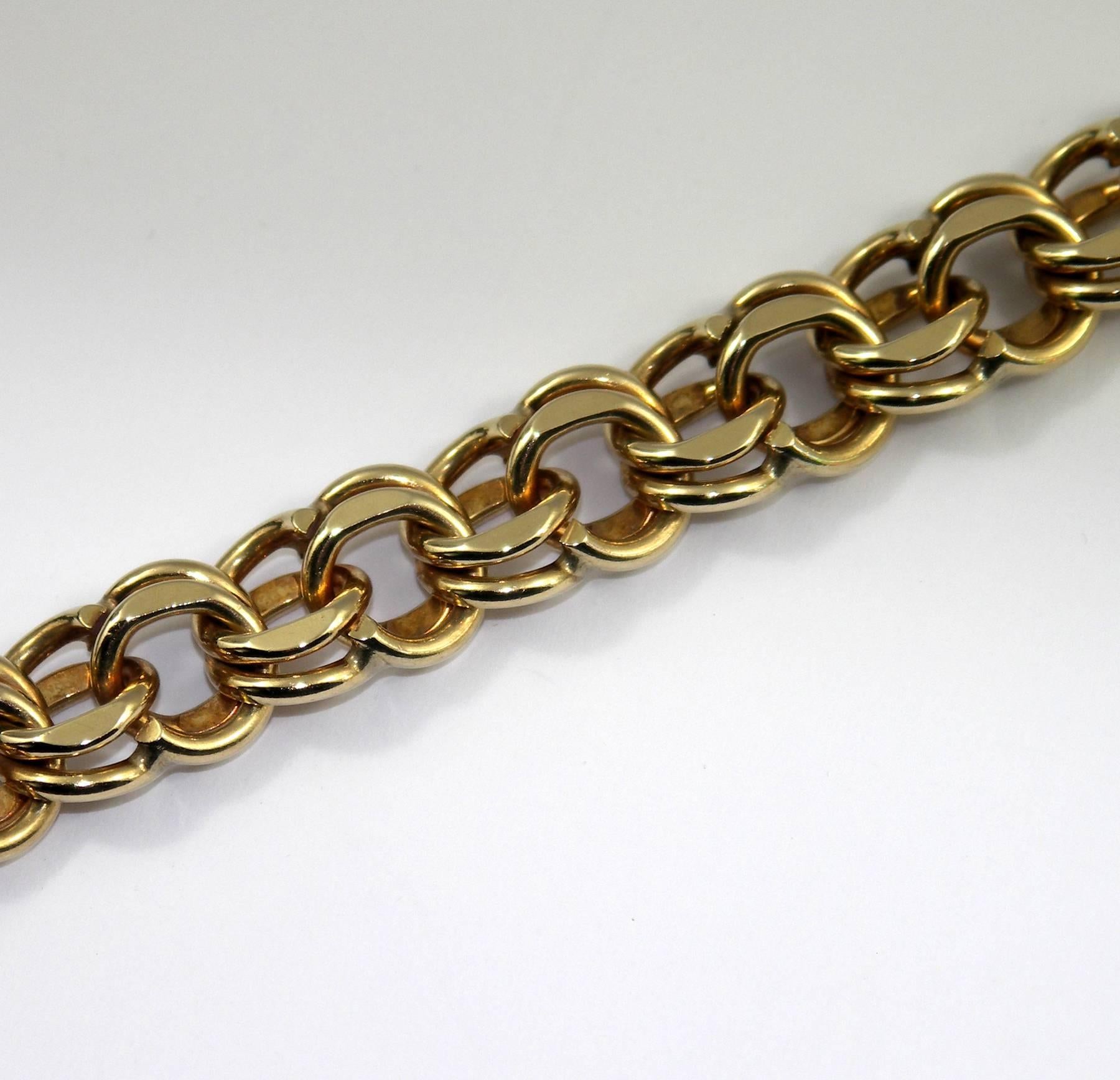 A 14K yellow gold double spiral link bracelet measuring 1/2 inch wide, and 7 1/4 inches long. This bracelet offers a terrific platform to create a charm bracelet. 
Weight 56 grams.