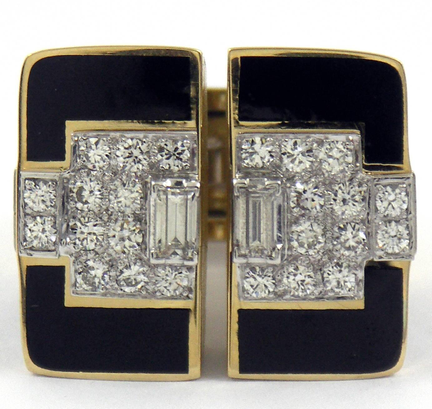 The strong, art deco platinum plates on top are set with two emerald cut and 20 round diamonds. There are 14 additional round diamonds set into platinum plates flanking the top and sides, for an approximate total of 2.25CT of overall G Color VS1