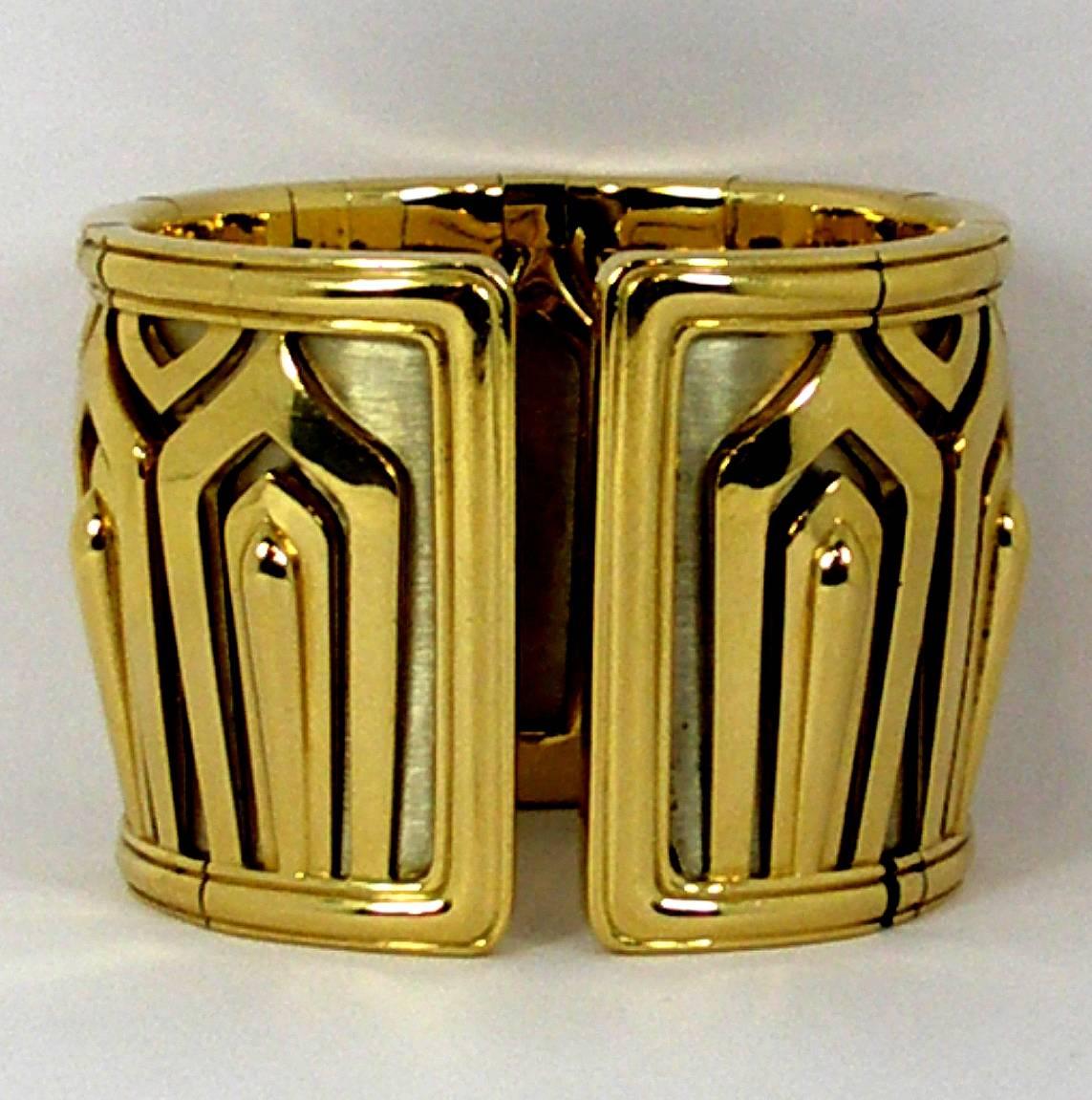 This rare, elegant Cartier cuff is made of 18K yellow gold, architectural motifs cut out over a background of 18k white gold. Measuring 1 7/8 inch wide (47mm), this outstanding Cartier cuff weighs a hefty 255 grams! Signed Cartier 750 and numbered