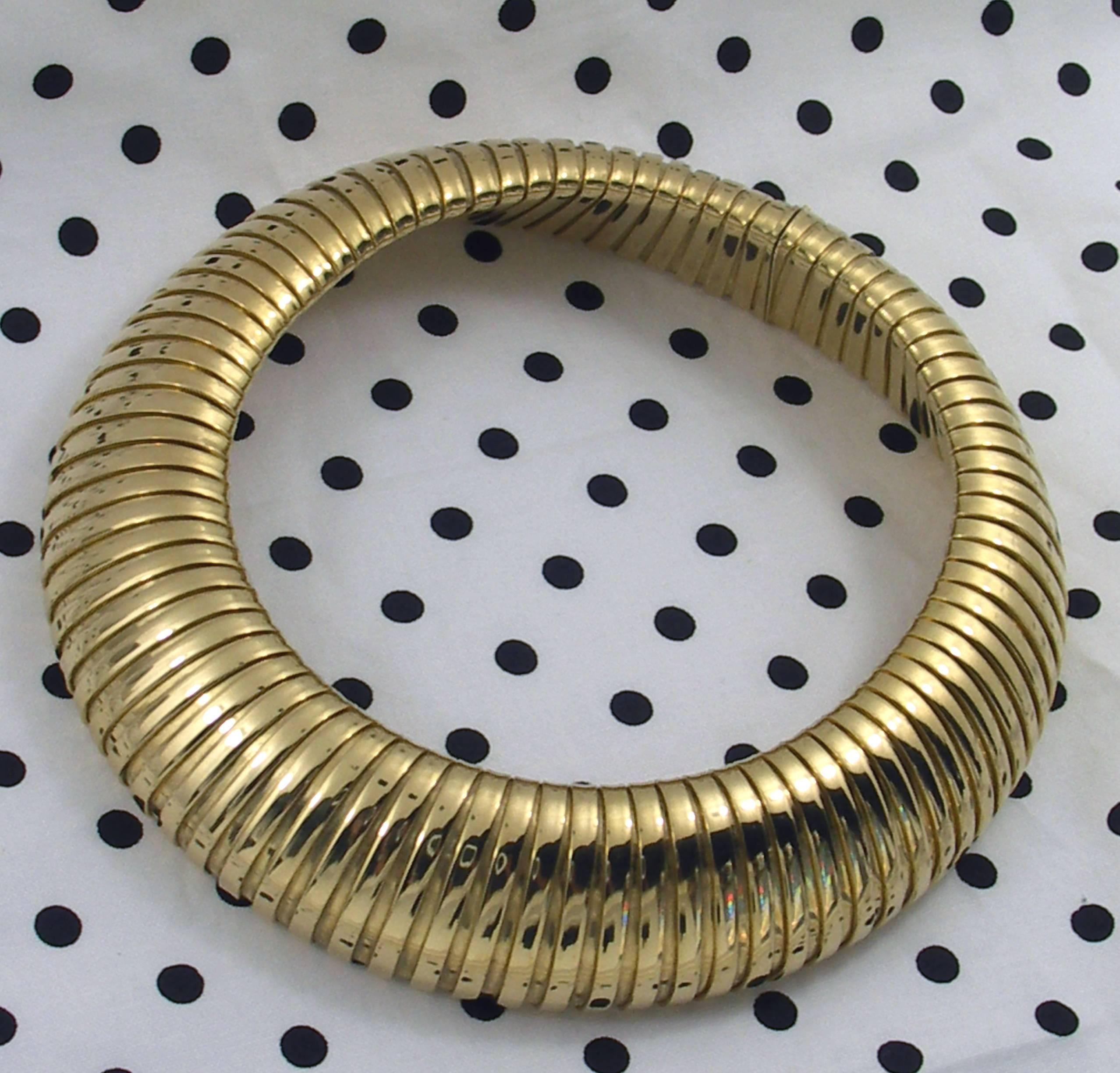 An 18K yellow gold Weingrill, choker length necklace. Designed in the gas tube style, it measures a substantial 1 1/4 inches wide. This beautifully finished collar will accommodate necks up to 16 1/2 inches.