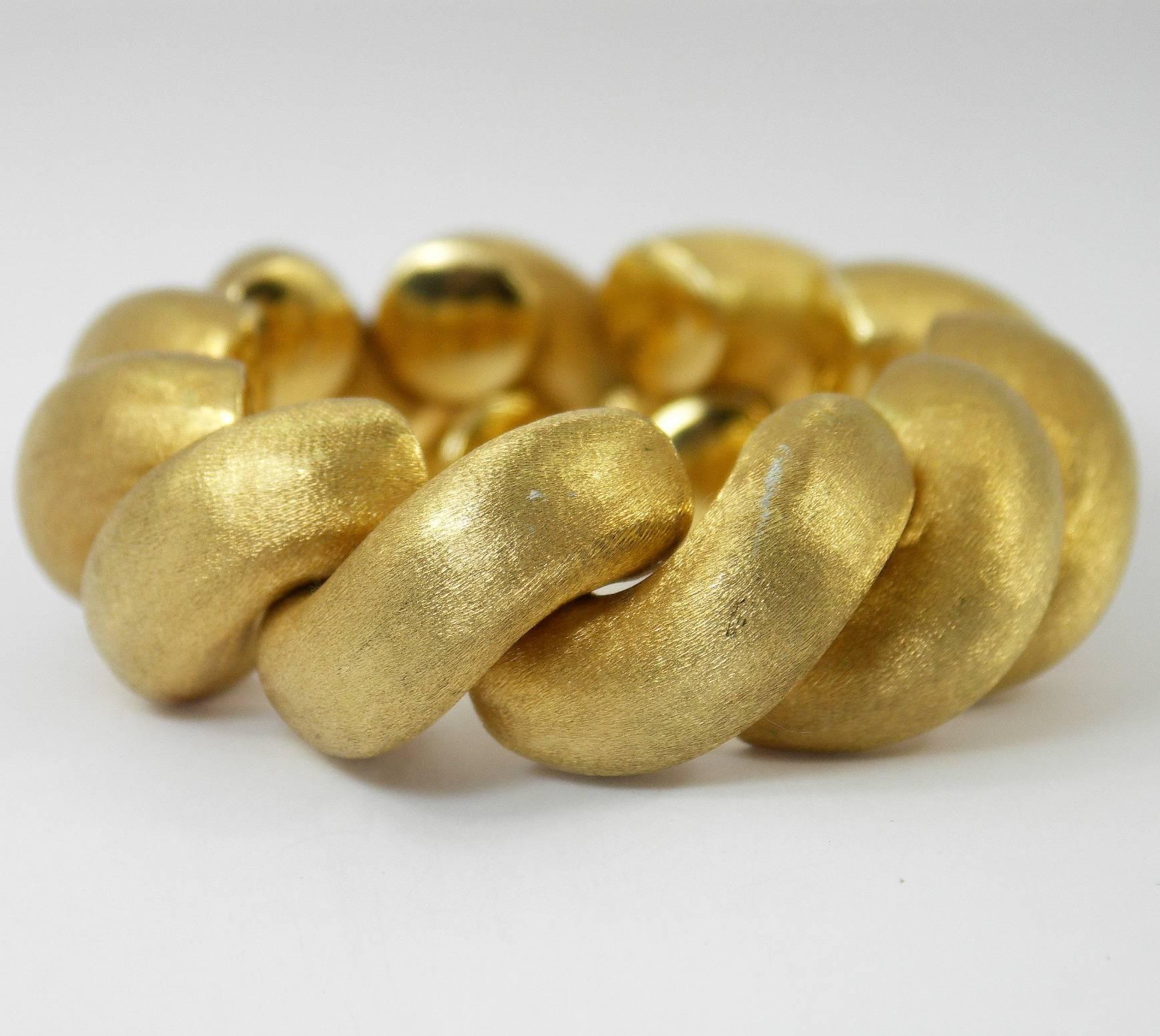 This rich looking, brushed finish San Marco bracelet was made in Italy
of 18K yellow gold. It measures a full 7 3/4