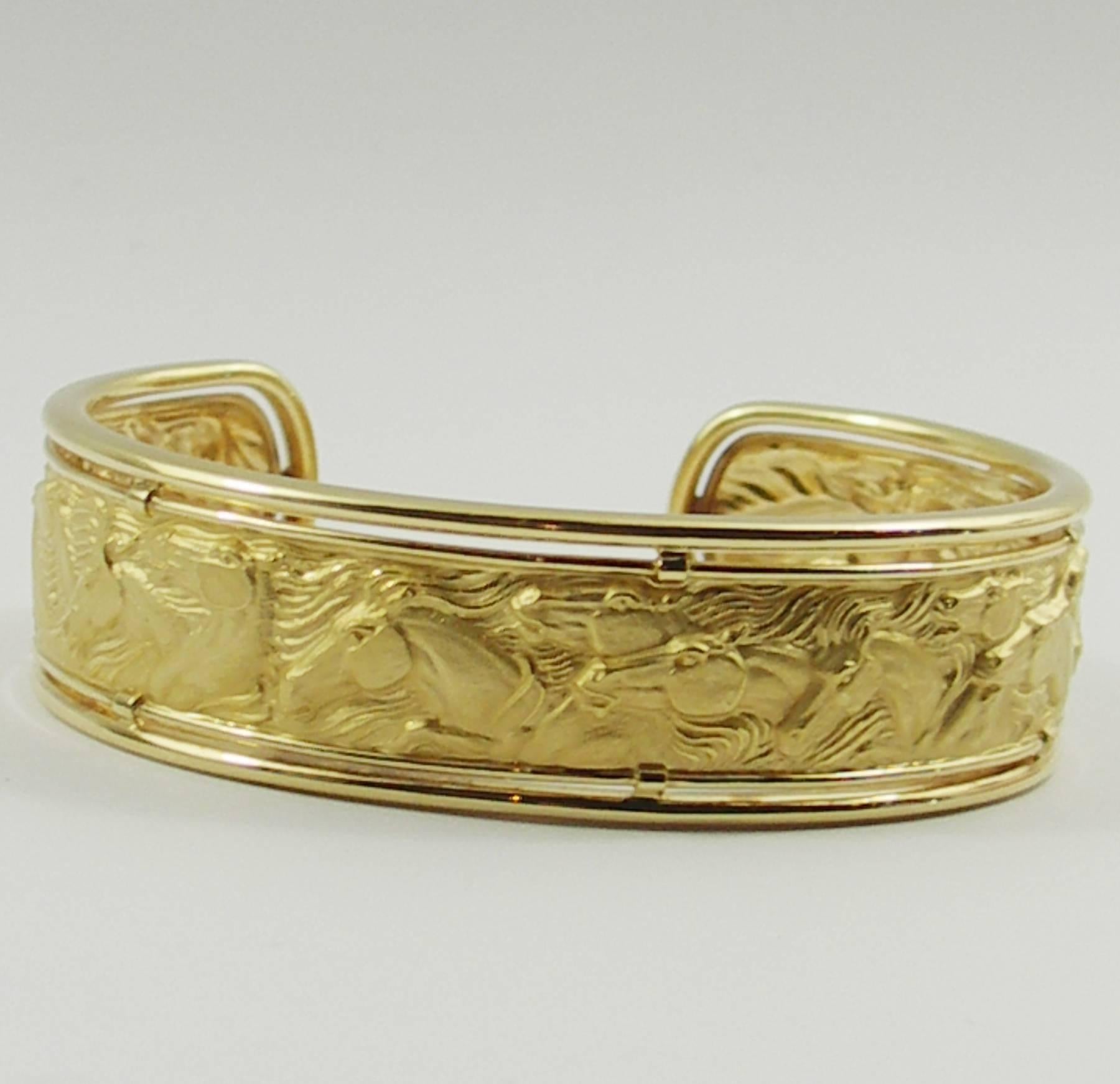 An 18K yellow gold Carrera y Carrera cuff measuring 3/4 of an inch wide, and 6 5/8 inches in circumference. This bracelet features horses with incredible detail. Will fit wrists up to 6 1/2 inches. Weight 24 grams.