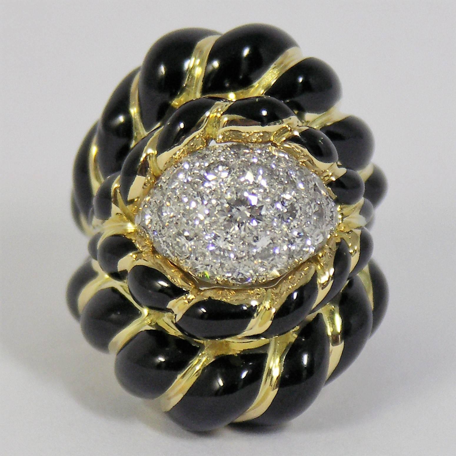 This handsome, black enamel twisted rope design, features a platinum, pave dome in the center, set with assorted round brilliant cut diamonds weighing an approximate total of 2.00ct. The sizing spring inside is signed WEBB PLAT 18K.
Presently the