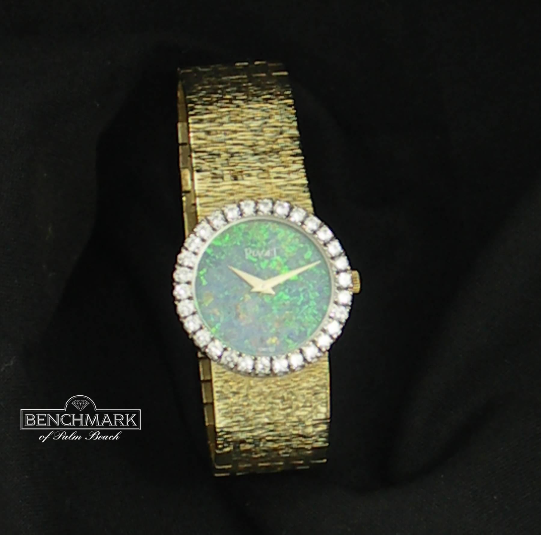 A ladies 18K yellow gold wristwatch centered around a rare opal dial, surrounded by a bezel, set with 30 round brilliant cut diamonds weighing 1.50ct total approximate weight. Case, dial, and quartz movement are each signed Piaget. The inside