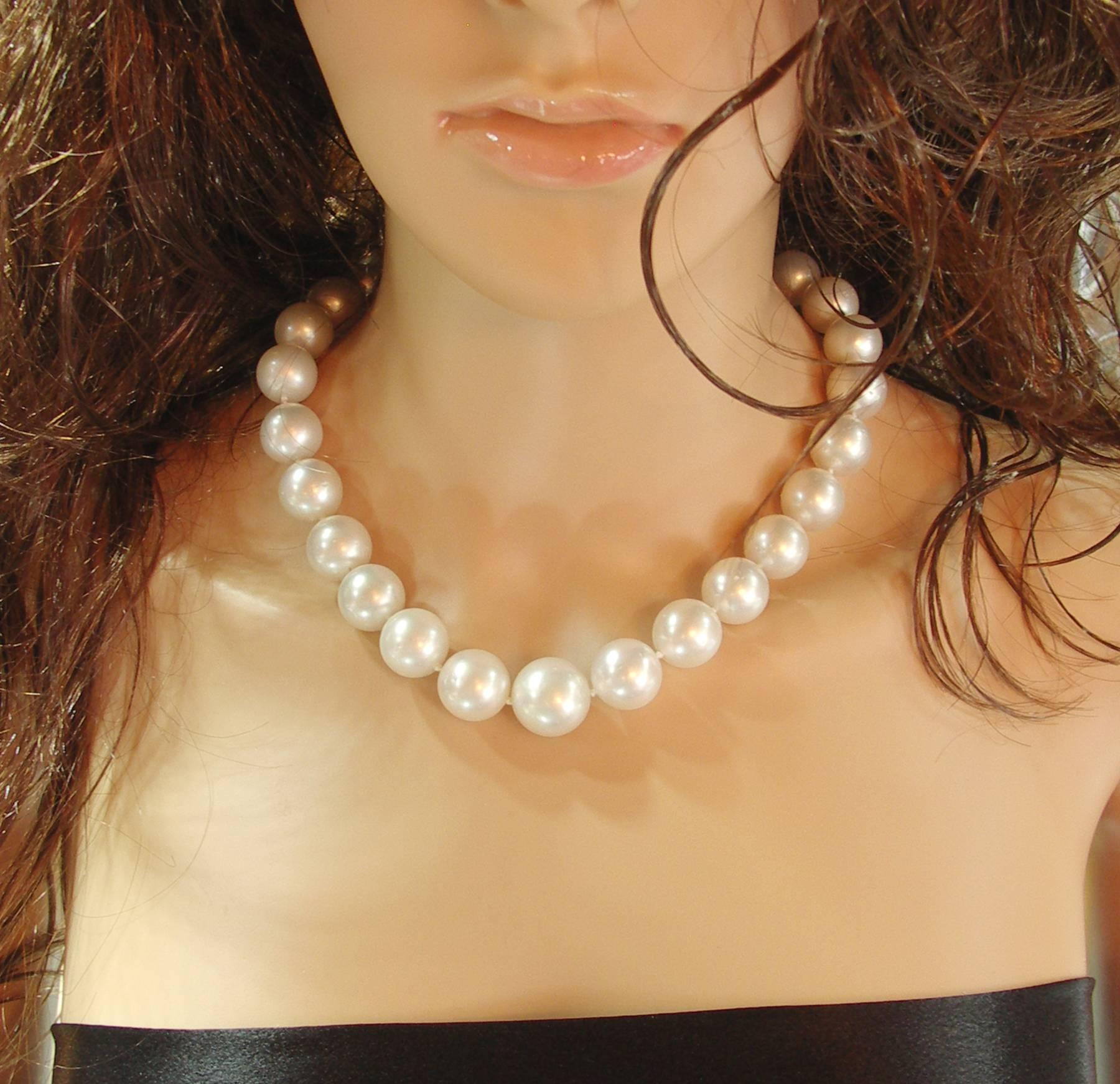 One Choker length strand of South Sea pearls, graduating from 14mm up to 18mm, of white bodycolor, and pink overtone. Luster is Very Good, and the surface has light to moderate spotting. The necklace is nicely finished with a platinum clasp set with