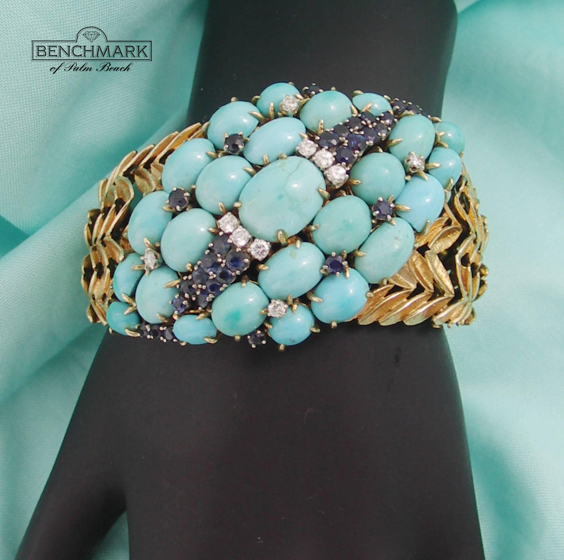 An 18K yellow gold bracelet, comprised of graduating organic motif links, set with cabochon cut turquoise, faceted sapphires, and round brilliant cut diamonds. There are a total of 30 sapphires weighing 3ct total approximate weight, and 10 diamonds