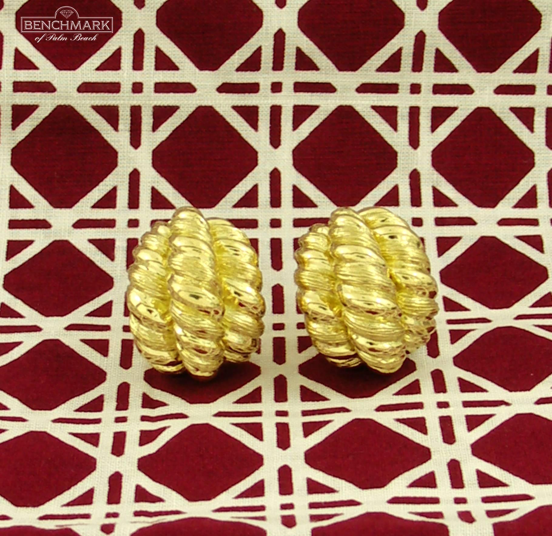 A pair of ladies, 18 karat yellow gold earrings measuring 7/8 of an inch wide, and 1 1/8 inch long, comprised of 3 rows of twisted rope design. With a bombe' front, they have an excellent scale and dimension. These fashionable mid-century earrings