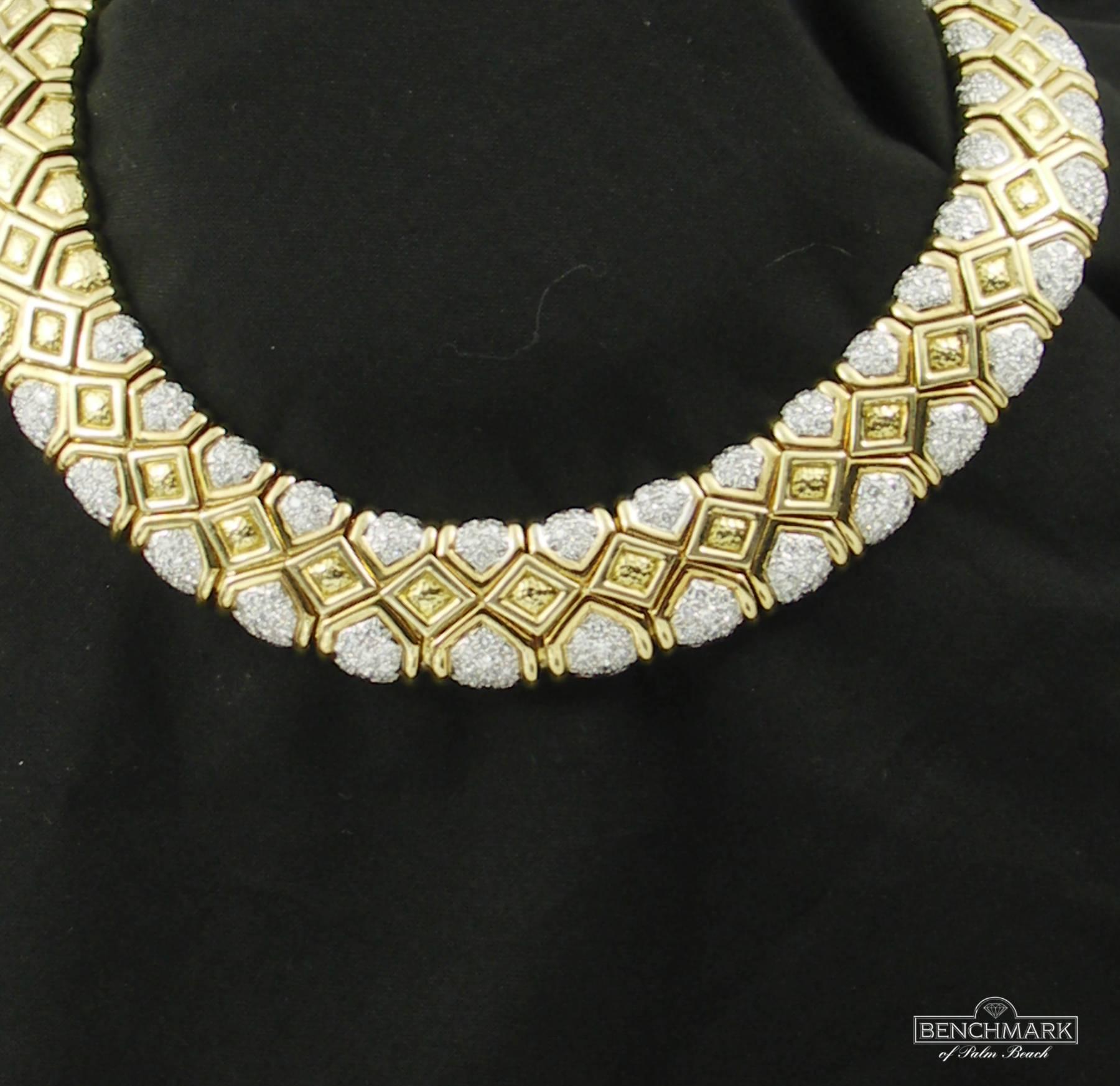 An 18K yellow gold necklace centered around a geometric design highlighted in polished gold, with the body of the necklace being hammer finished. The 17 links in the center are set top and bottom with round brilliant cut diamonds weighing a total of