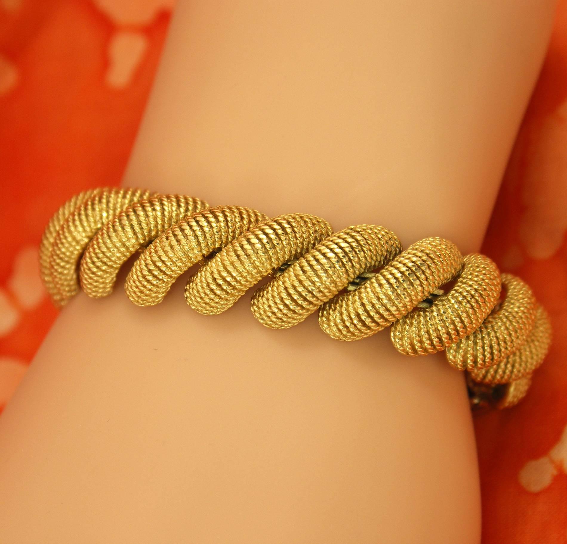 A ladies 18K yellow gold San Marco bracelet, measuring 5/8 of an inch wide and 7 inches long. Each link is comprised of twisted rope adding texture, to the bracelet's already rich yellow gold.  Weight 77 grams.