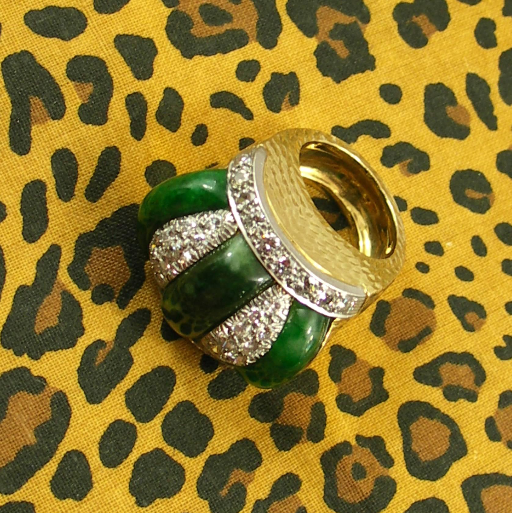 A jade and diamond ring from David Webb, comprised of an 18K hammered gold chassis, upon which sits a dome of jade, and diamonds. The diamonds are set in platinum, and weigh 2.25ct, total approximate weight. The center strip of jade measures 7mm